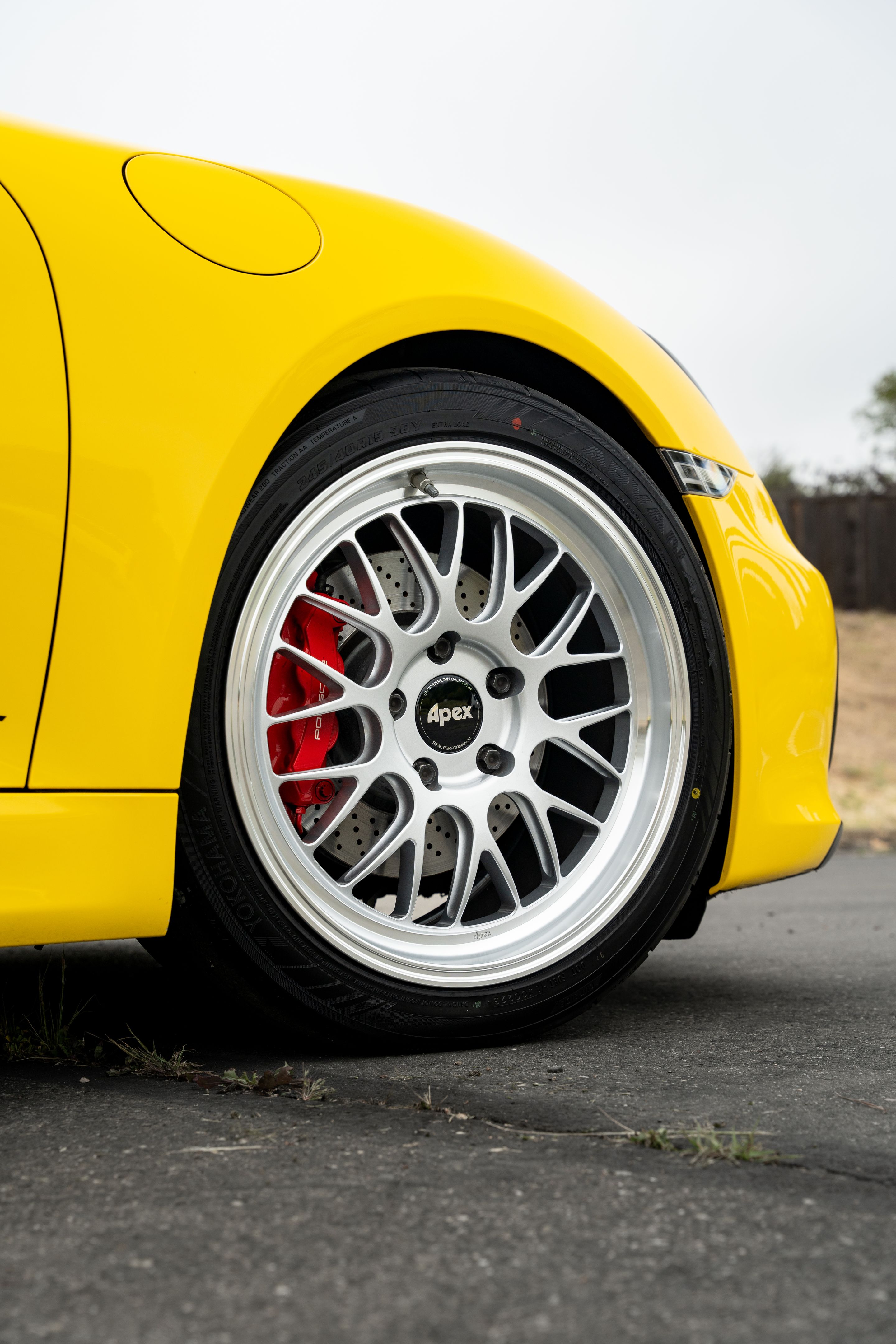 Yellow Porsche 981 Cayman GTS with 19" ML-10RT Apex wheels in Machined Lip Race Silver