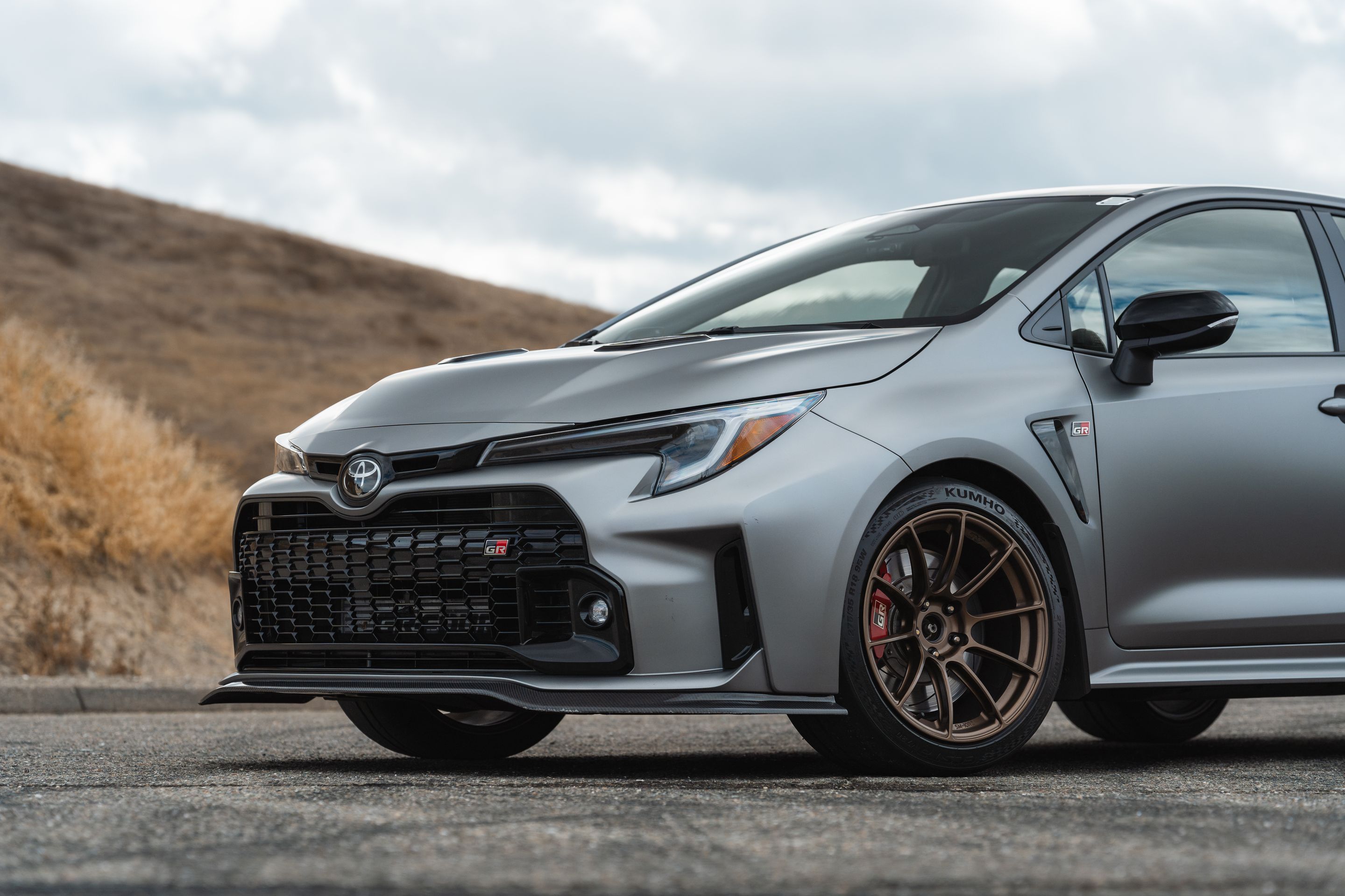 Grey Toyota GR Corolla with 18" SM-10RS Apex wheels in Satin Bronze