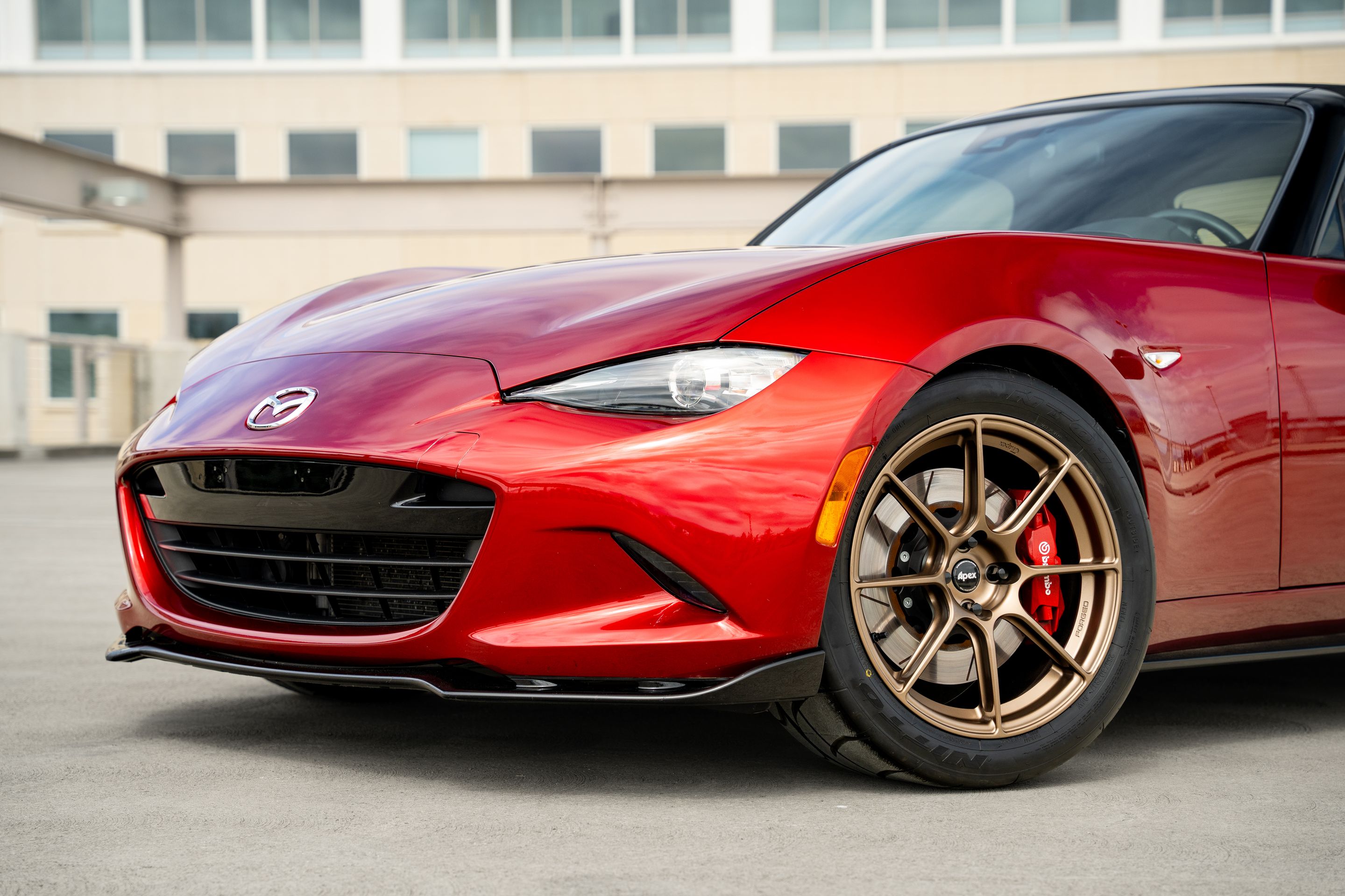Red Mazda ND MX-5 Miata with 17" SM-8RS Apex wheels in Satin Bronze