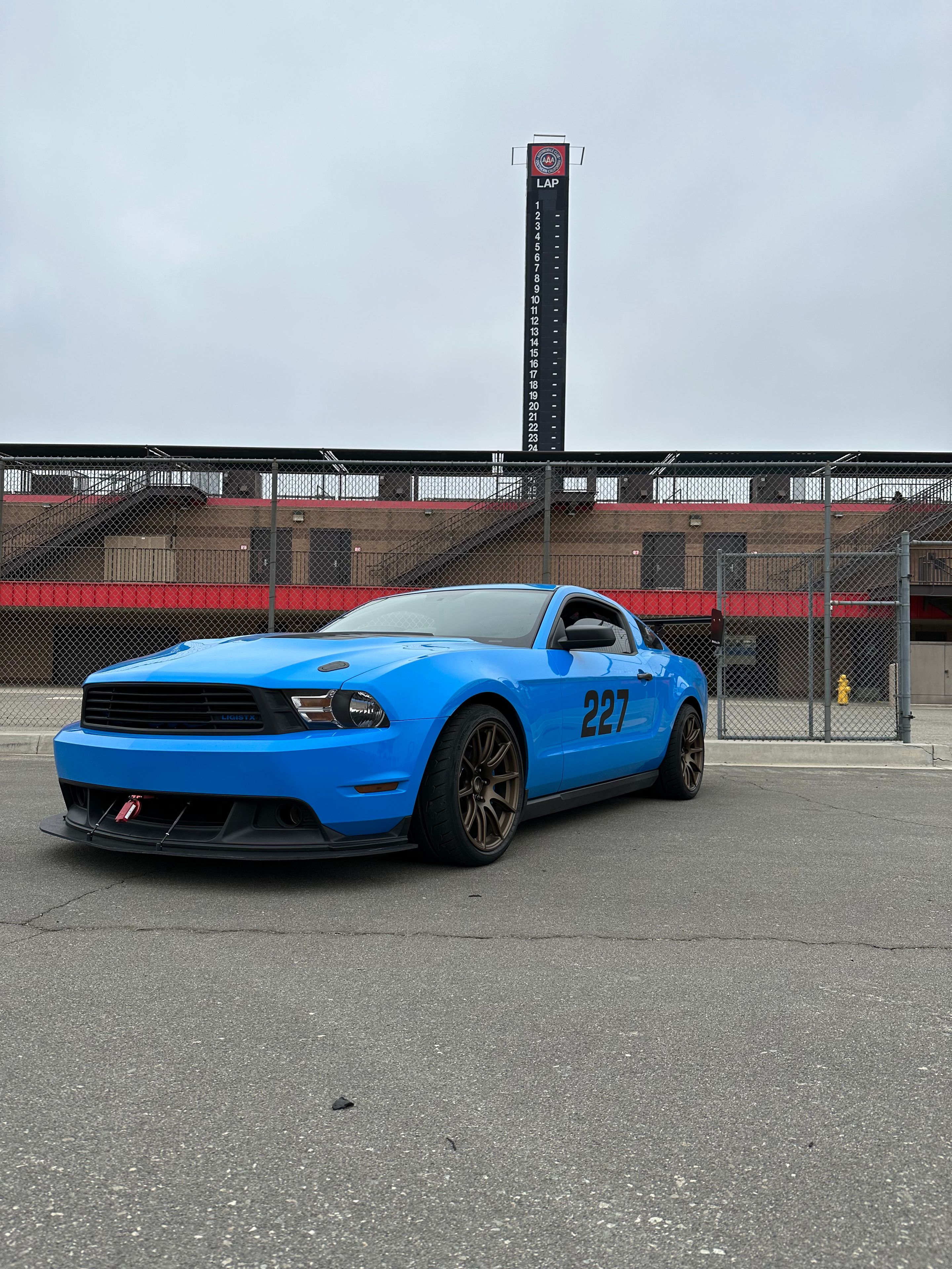 Blue Ford S197 Mustang V6 with 18" SM-10 Apex wheels in Satin Bronze