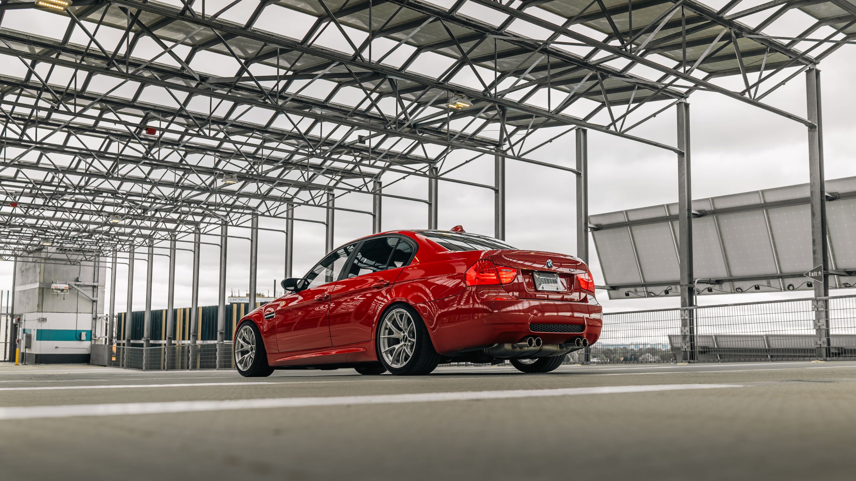 Red BMW E90 Sedan M3 with 18" VS-5RS Apex wheels in Brushed Clear