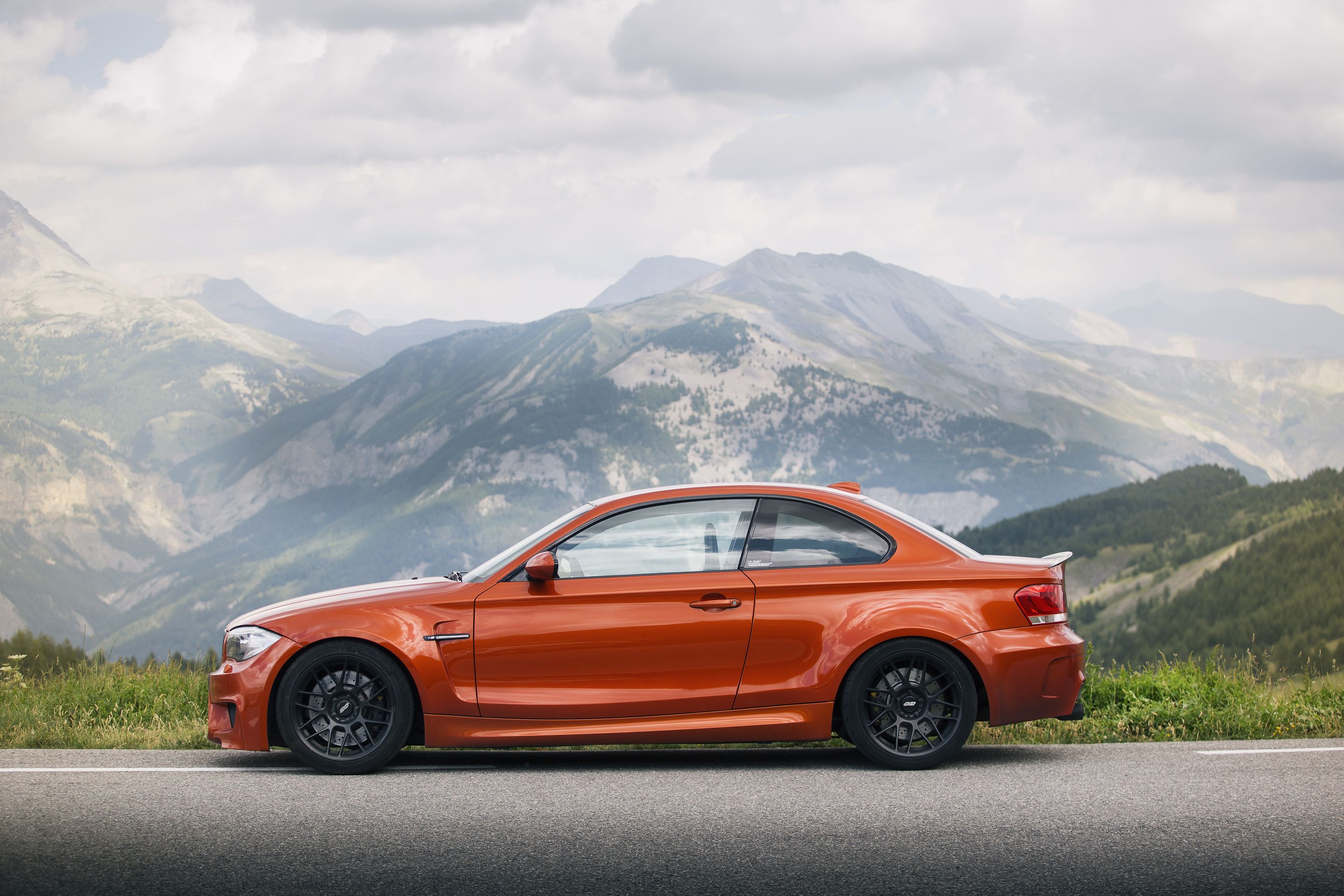 Orange BMW E82 1M with 18" ARC-8 Apex wheels in Satin Black