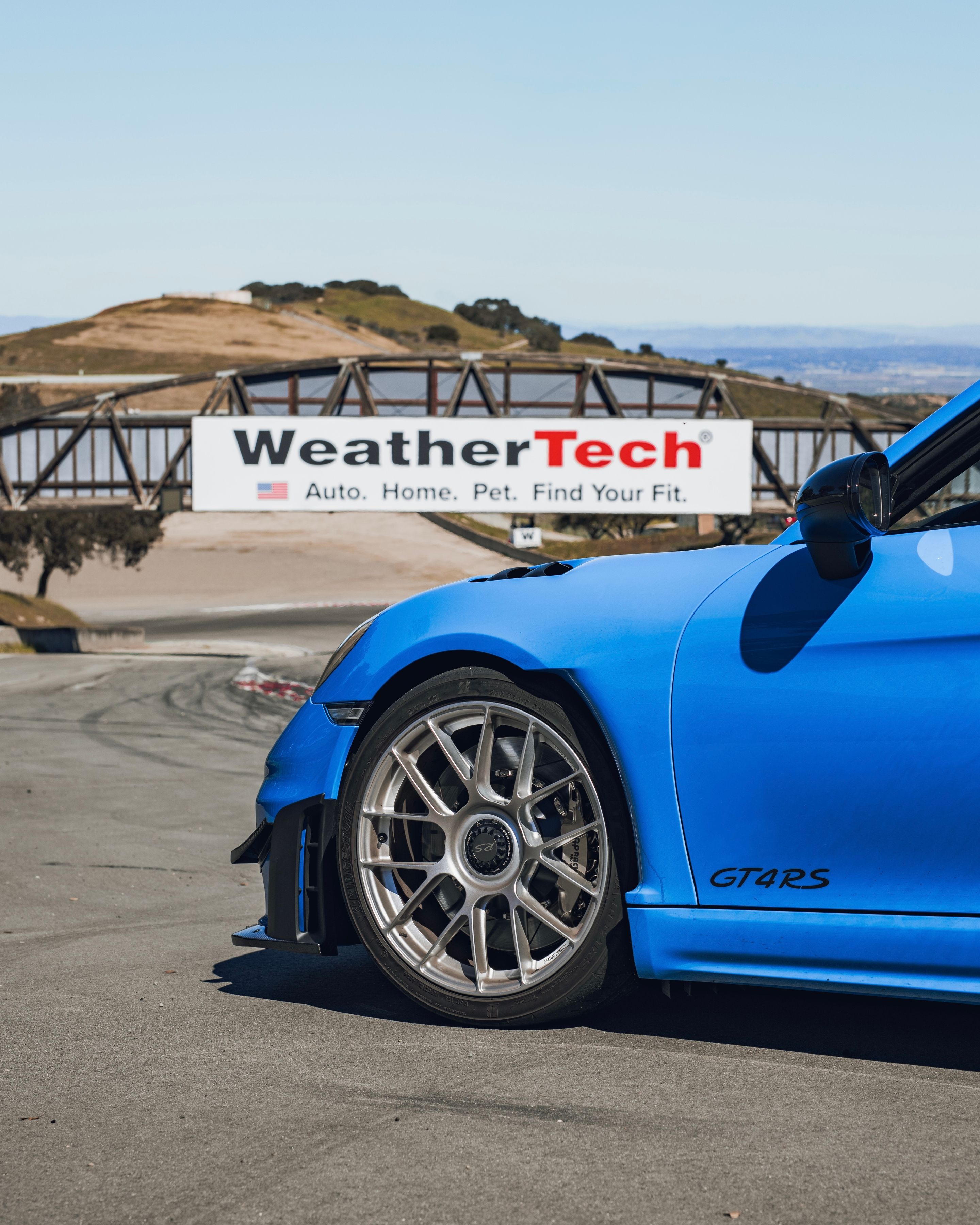 Blue Porsche 718 Cayman GT4 RS with 19" EC-7RS Apex wheels in Race Silver