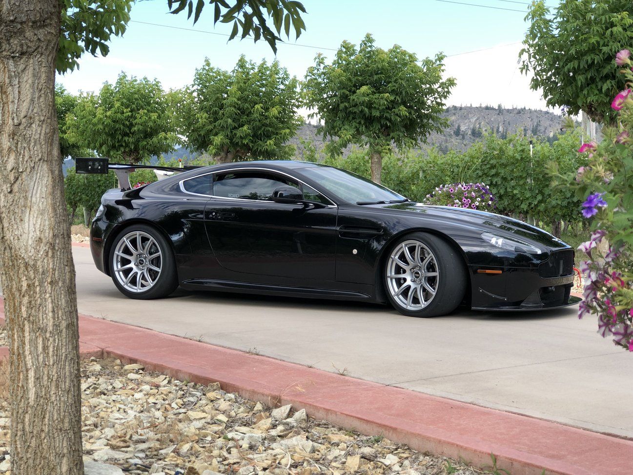 Black Aston Martin V8/V12 Vantage with 19" SM-10 Apex wheels in Race Silver
