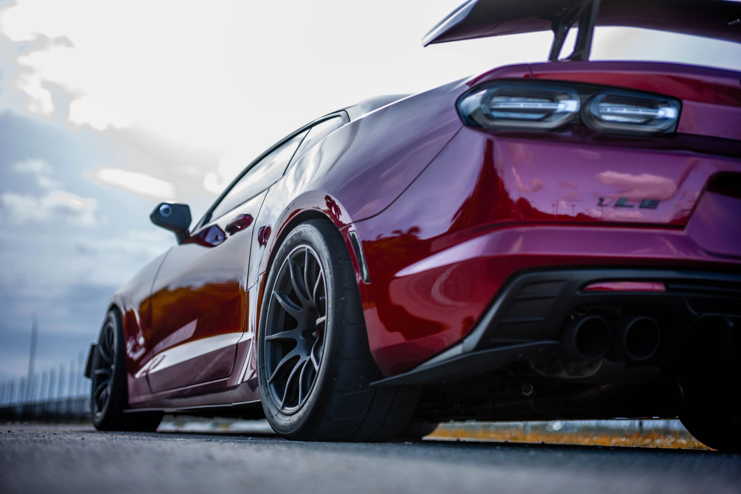 Red Chevrolet 6th Gen Camaro SS with 19" SM-10 Apex wheels in Satin Black