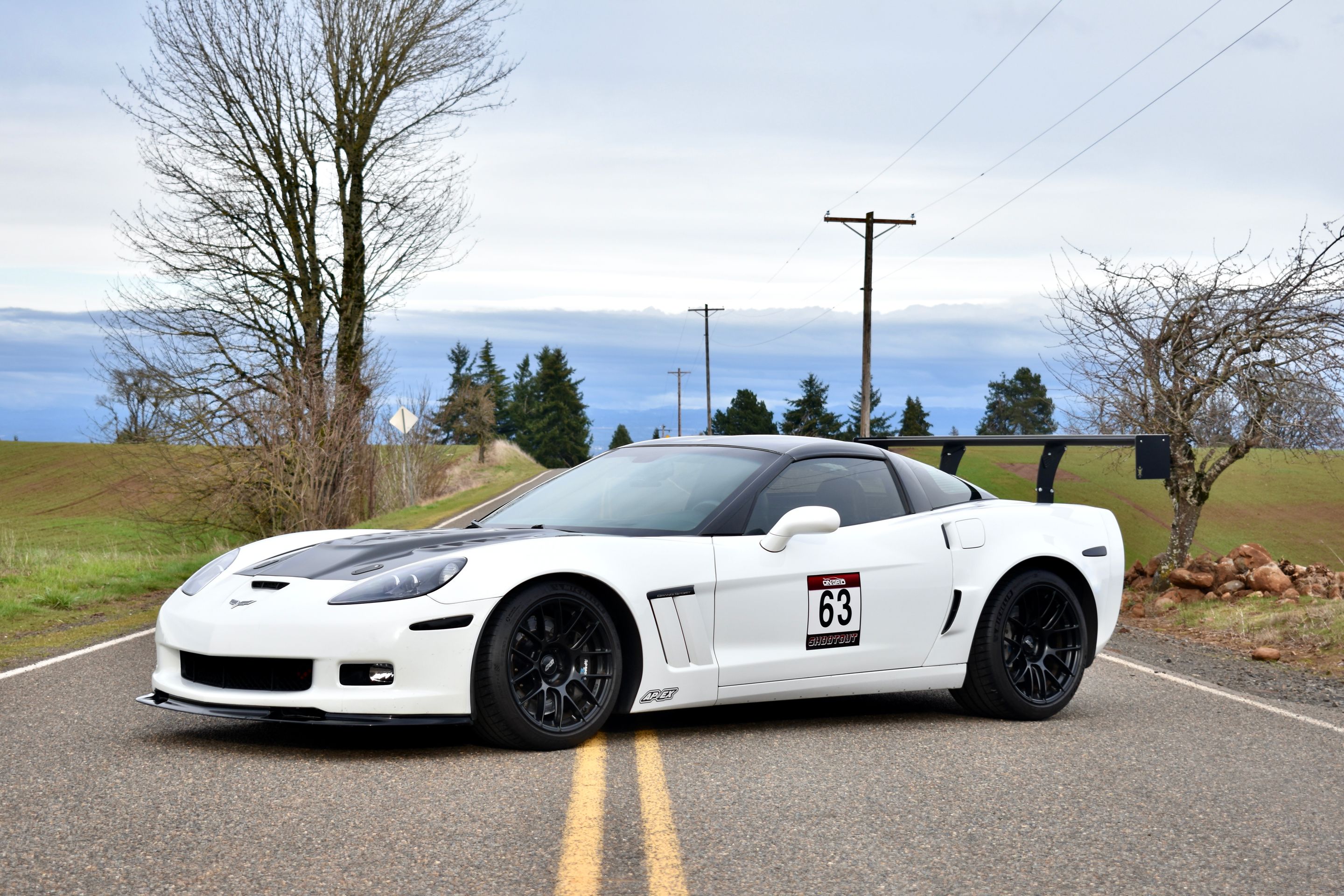 White Chevrolet C6 Corvette Grand Sport with 18"/19" EC-7RS Apex wheels in Satin Black