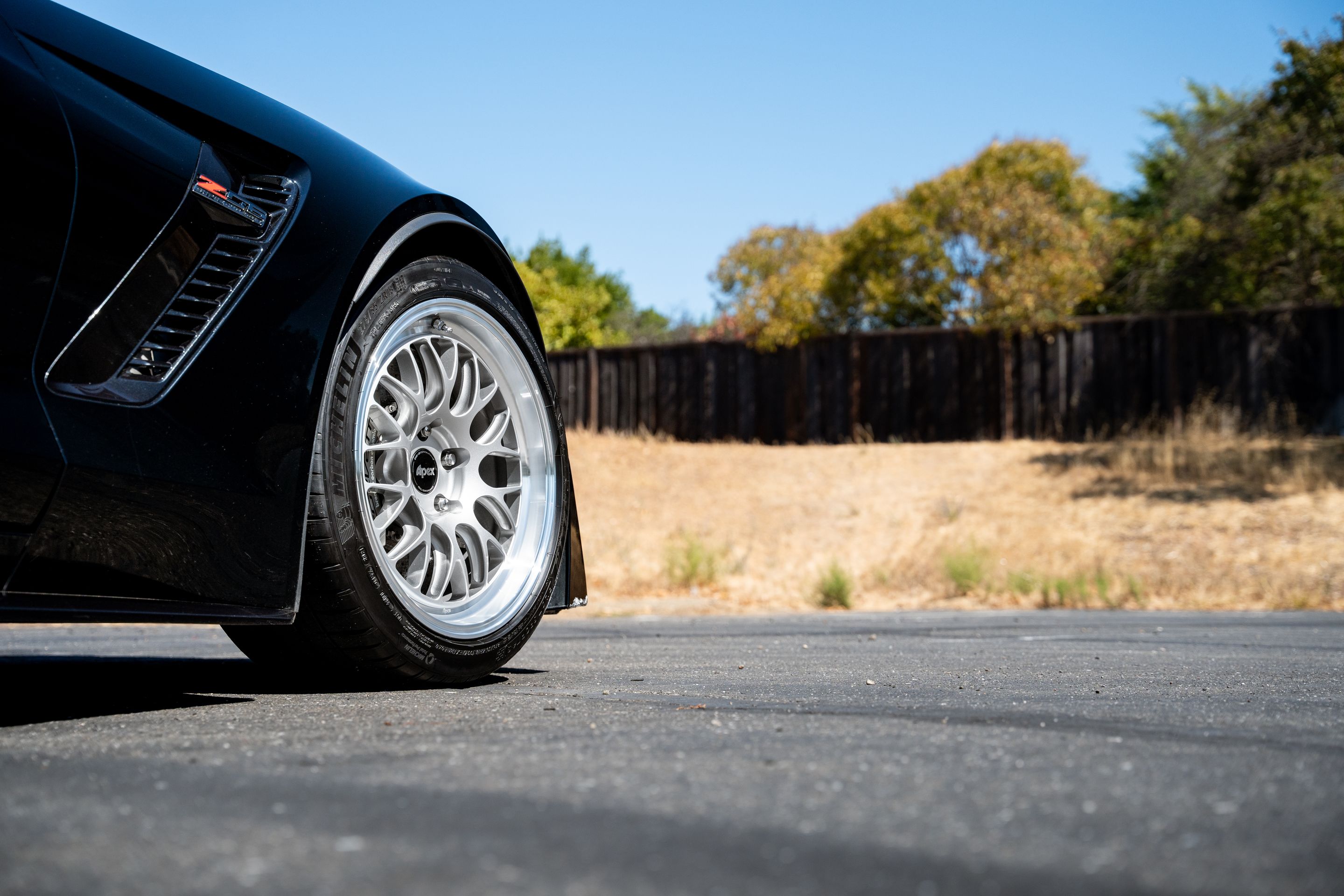 Black Chevrolet C7 Corvette Z06 with 18"/19" ML-10RT Apex wheels in Machined Lip Race Silver