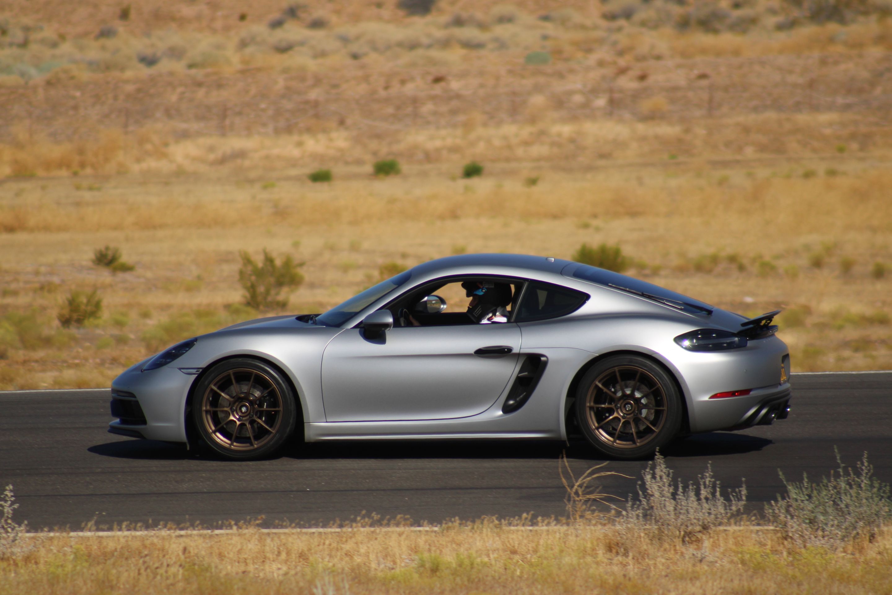 Silver Porsche 718 Cayman GTS 4.0L with 19" SM-10RS Apex wheels in Satin Bronze