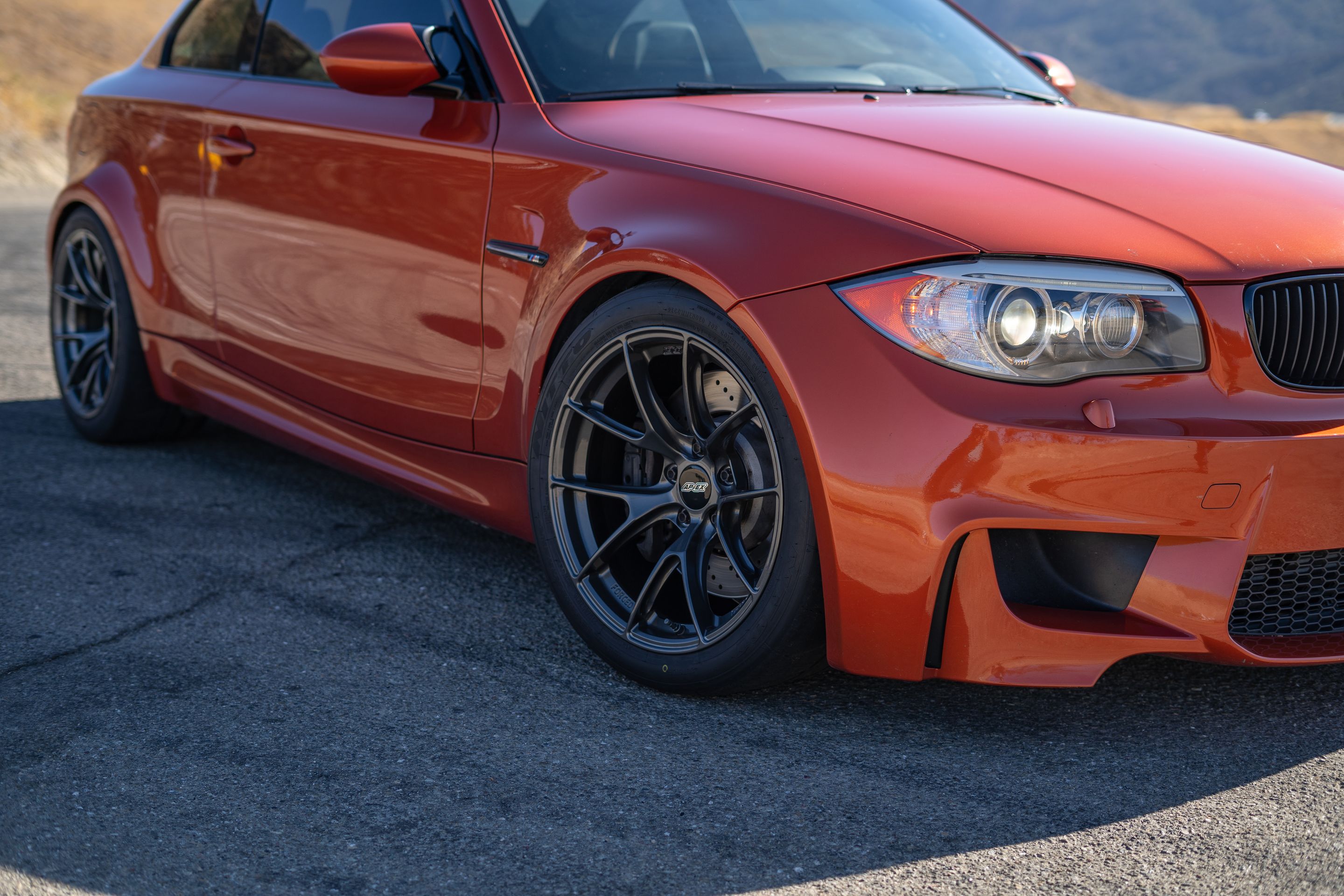 Orange BMW E82 1M with 18" VS-5RS Apex wheels in Anthracite