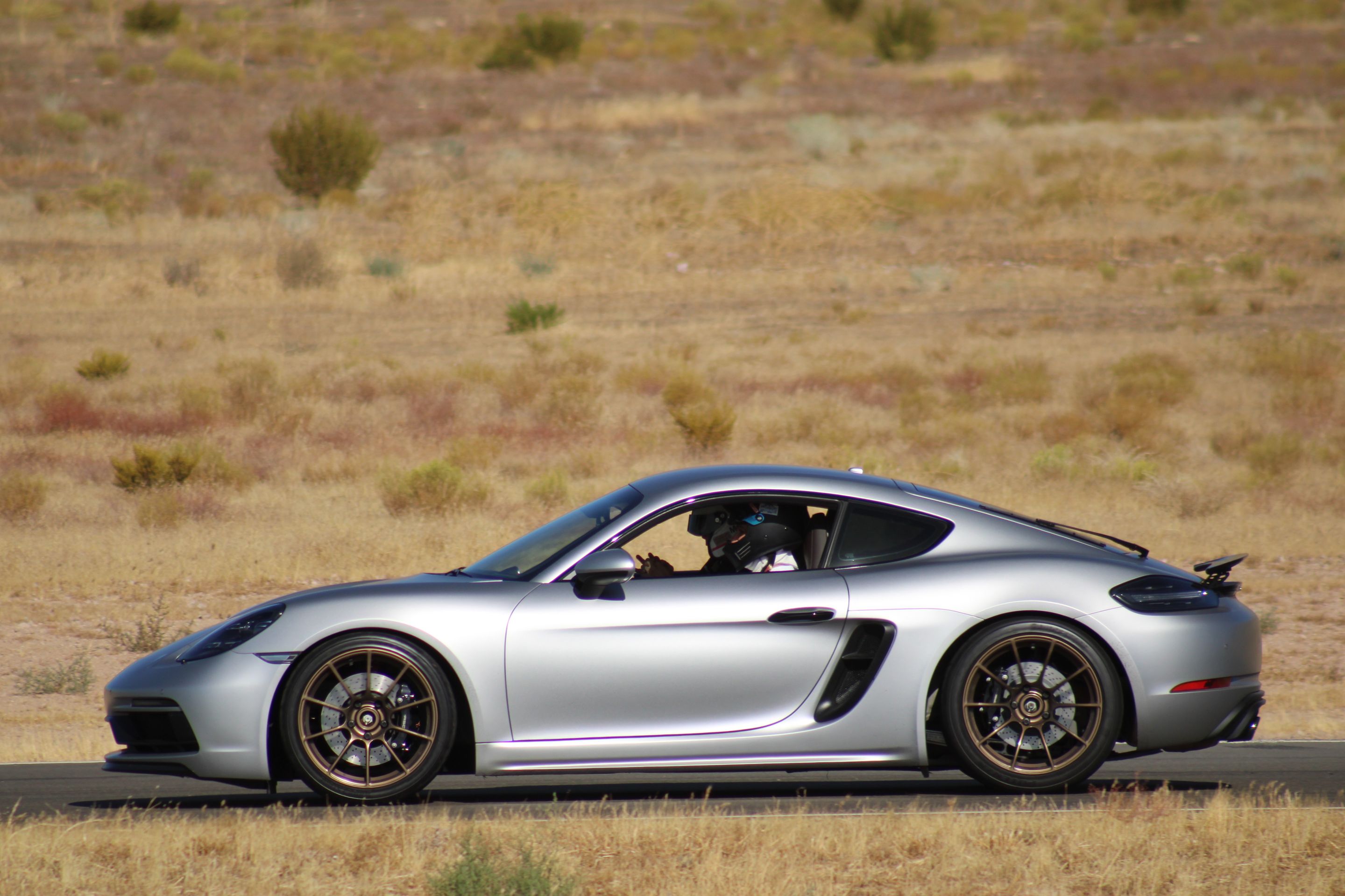 Silver Porsche 718 Cayman GTS 4.0L with 19" SM-10RS Apex wheels in Satin Bronze