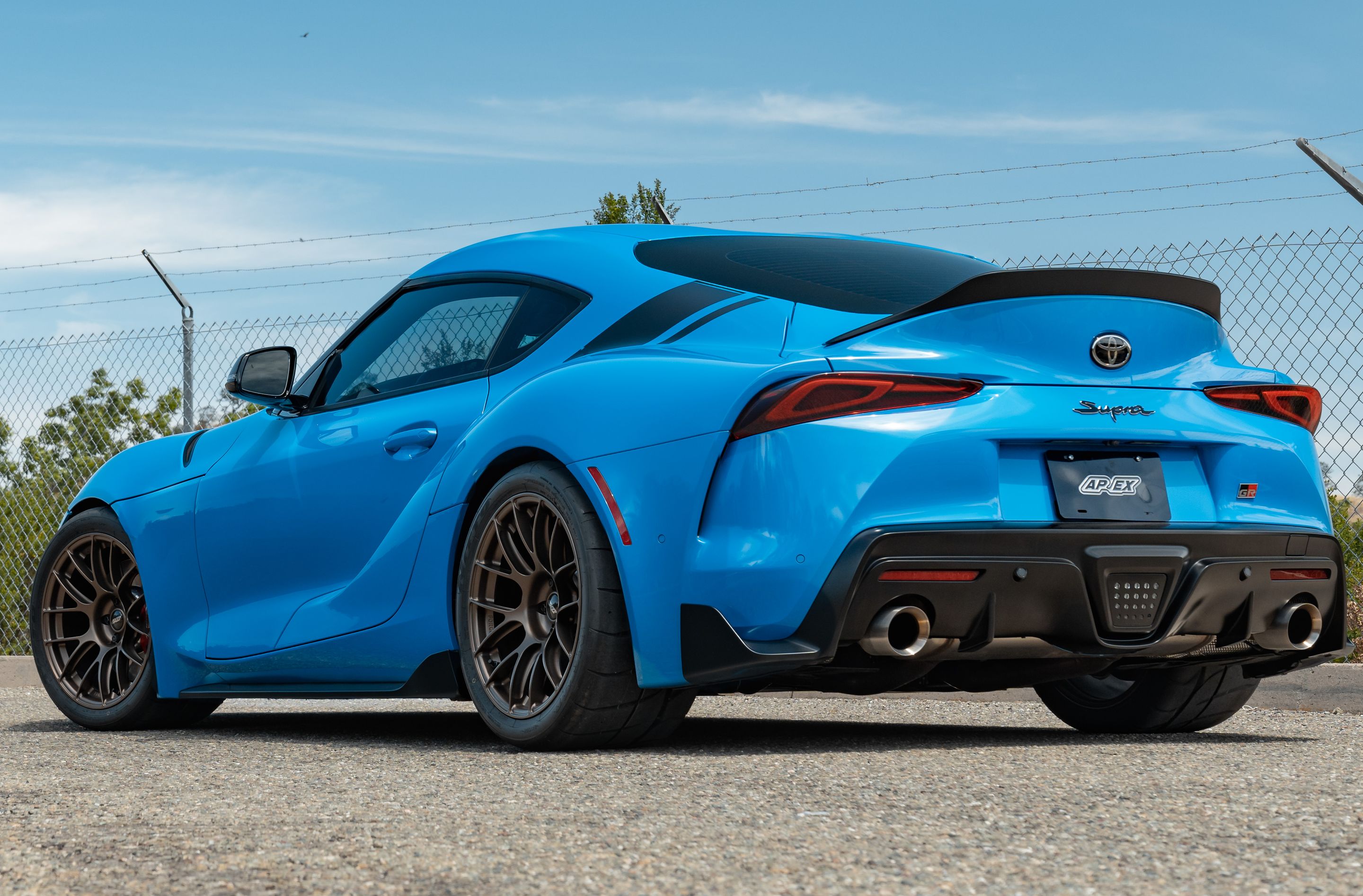 Blue Toyota GR Supra with 18" EC-7RS Apex wheels in Satin Bronze