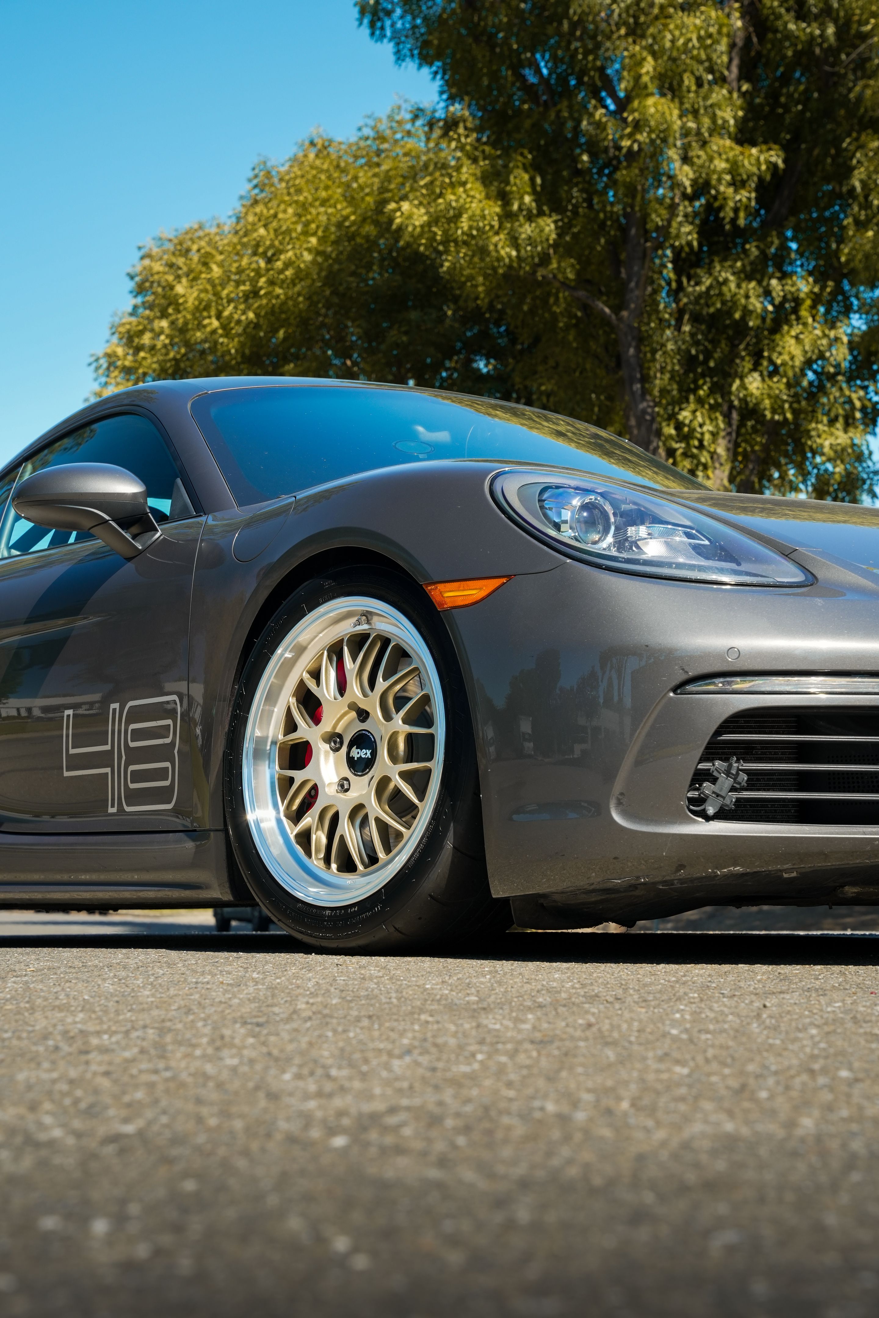 Grey Porsche 718 Cayman S with 18" ML-10RT Apex wheels in Machined Lip Gloss Motorsport Gold