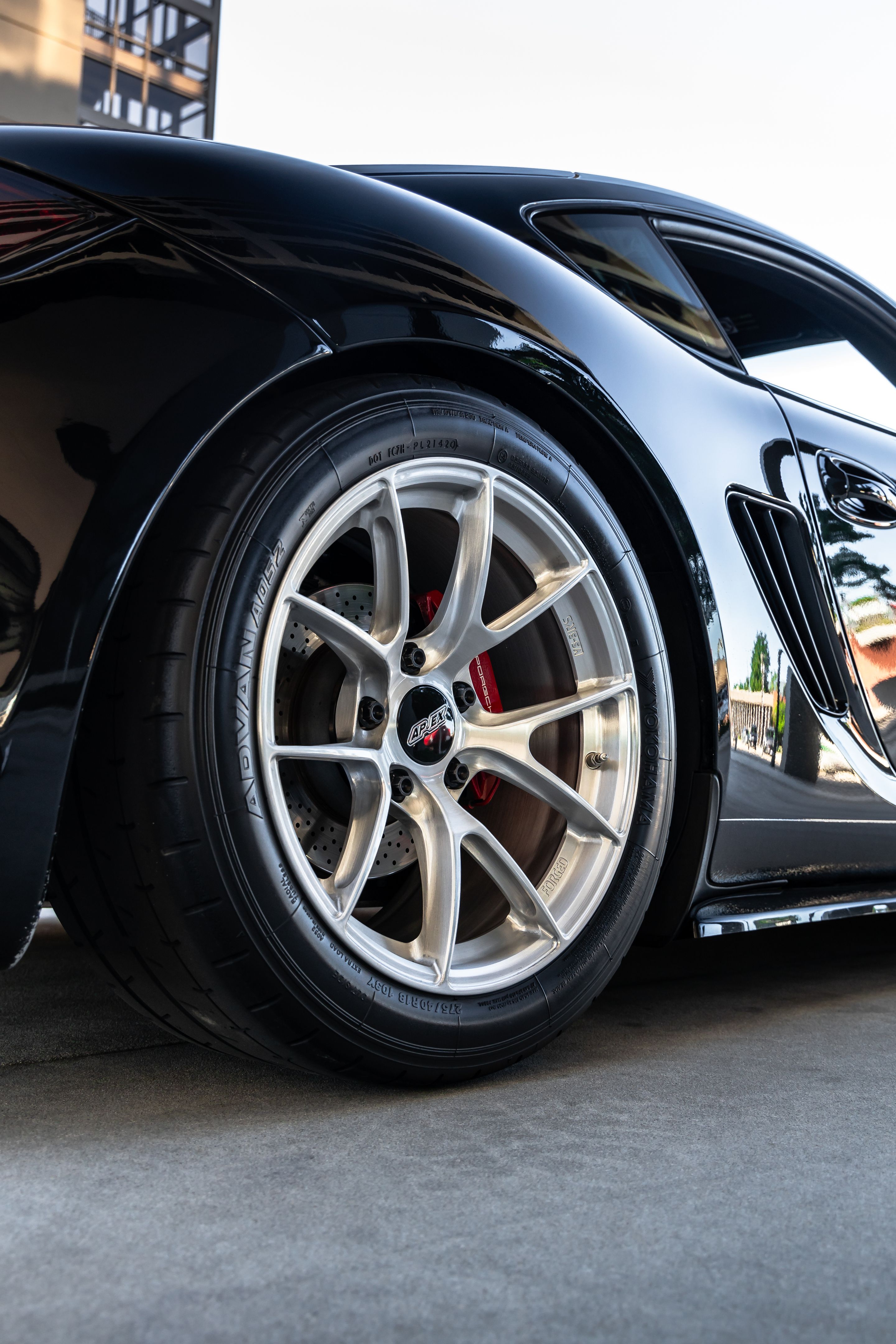 Black Porsche 987 Cayman S with 18" VS-5RS Apex wheels in Brushed Clear