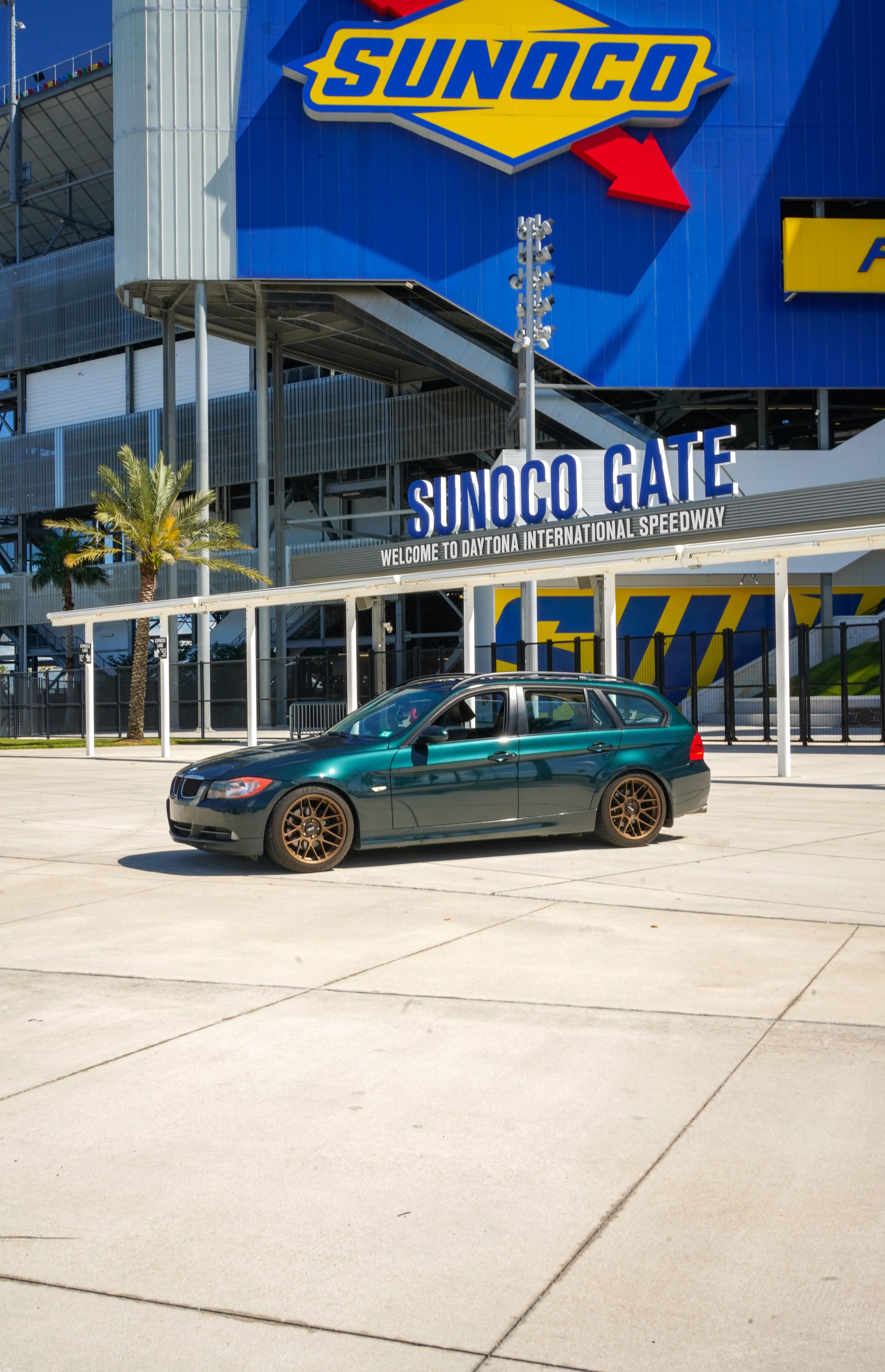 Green BMW E91 Wagon 3 Series with 18" ARC-8 Apex wheels in Satin Bronze