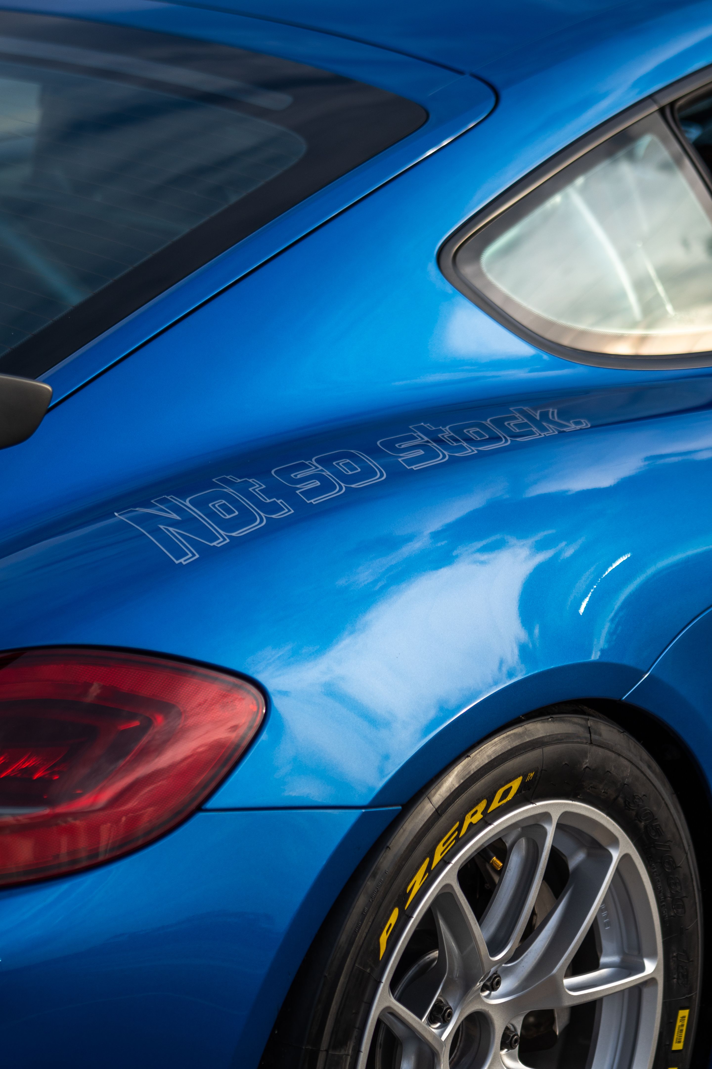 Blue Porsche 981 Cayman GT4 with 18" VS-5RE Apex wheels in Race Silver