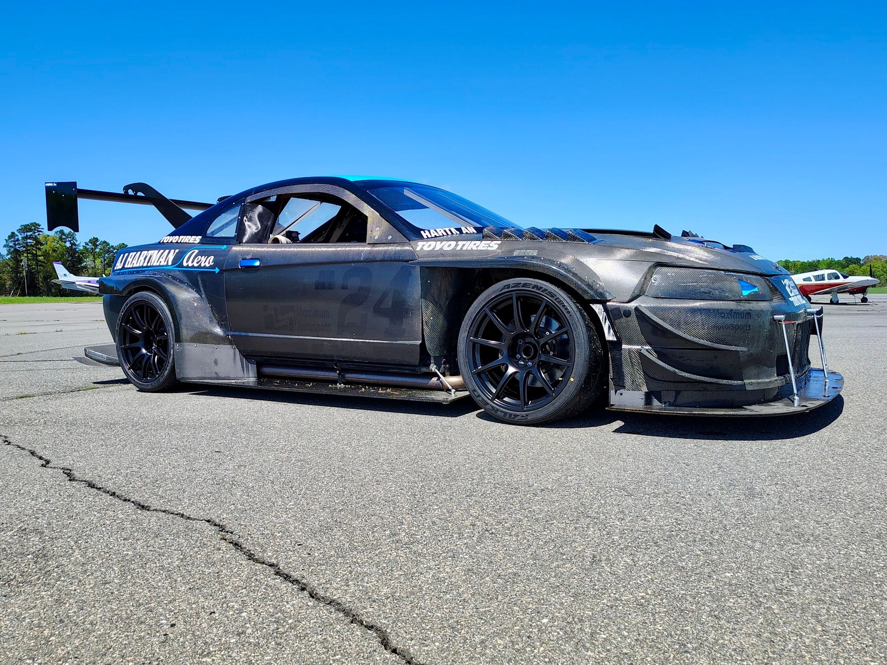 Black Ford SN95 Mustang V6 with 19" SM-10 Apex wheels in Satin Black