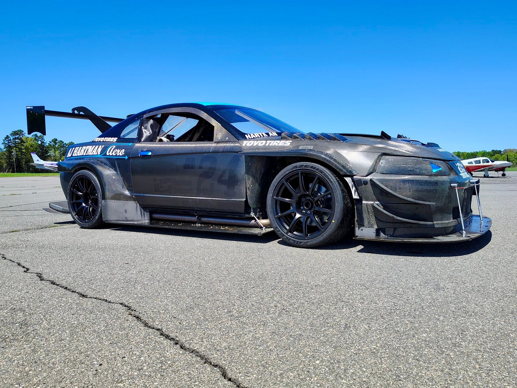 Black Ford SN95 Mustang V6 with 19" SM-10 Apex wheels in Satin Black