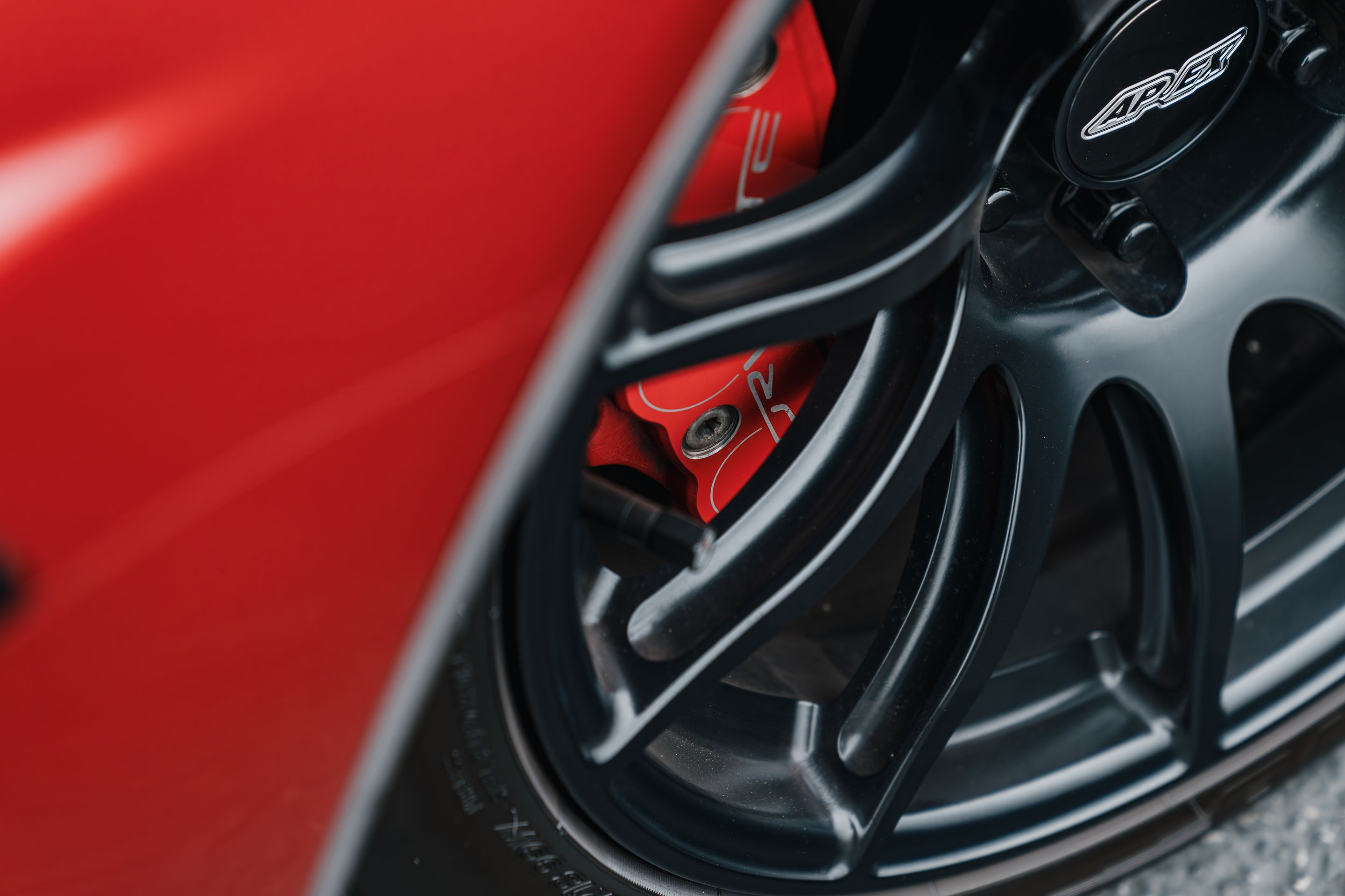 Red Chevrolet C6 Corvette Z06 with 18"/19" SM-10 Apex wheels in Satin Black