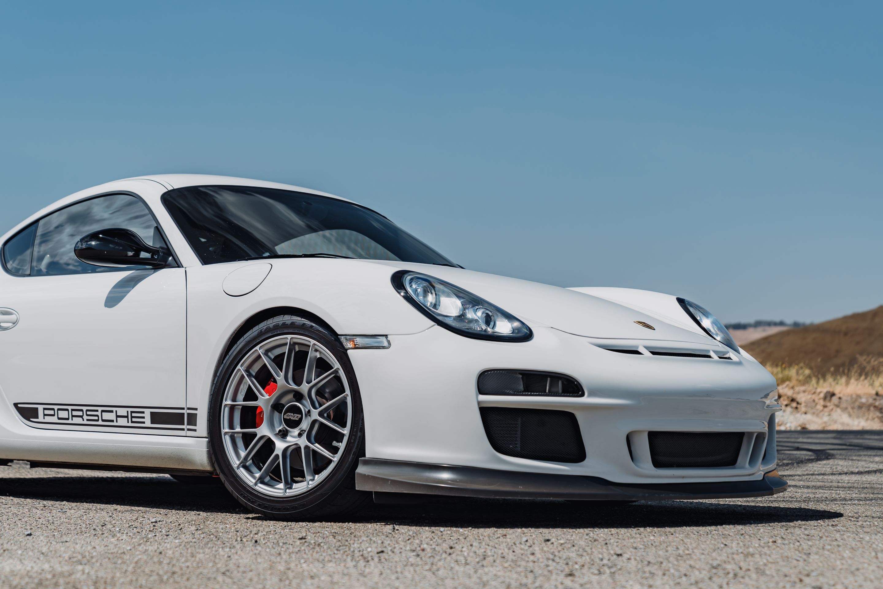 White Porsche 987 Cayman R with 18" EC-7RS Apex wheels in Race Silver