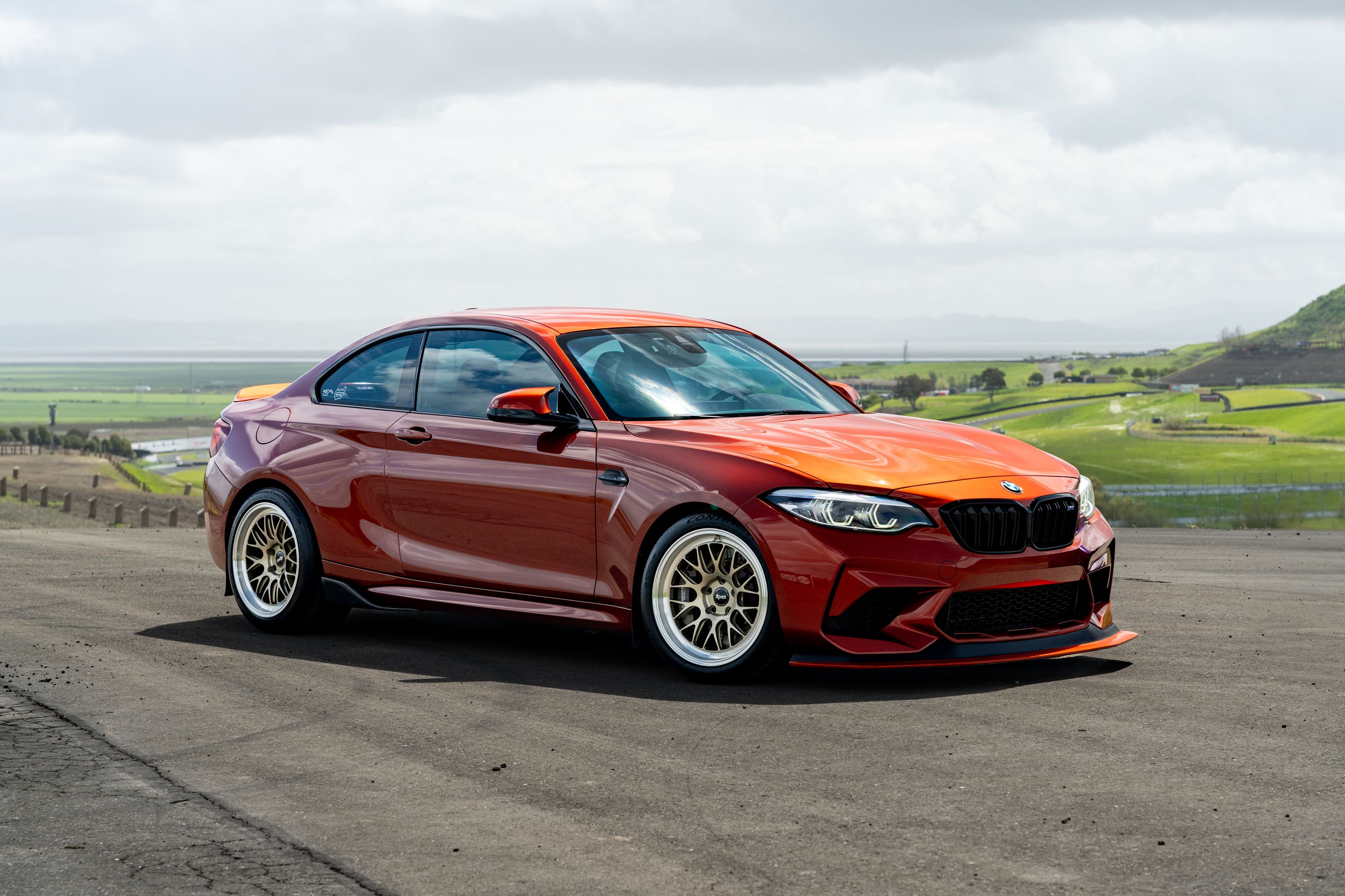 Orange BMW F87 M2 with 18" ML-10RT Apex wheels in Machined Lip Gloss Motorsport Gold