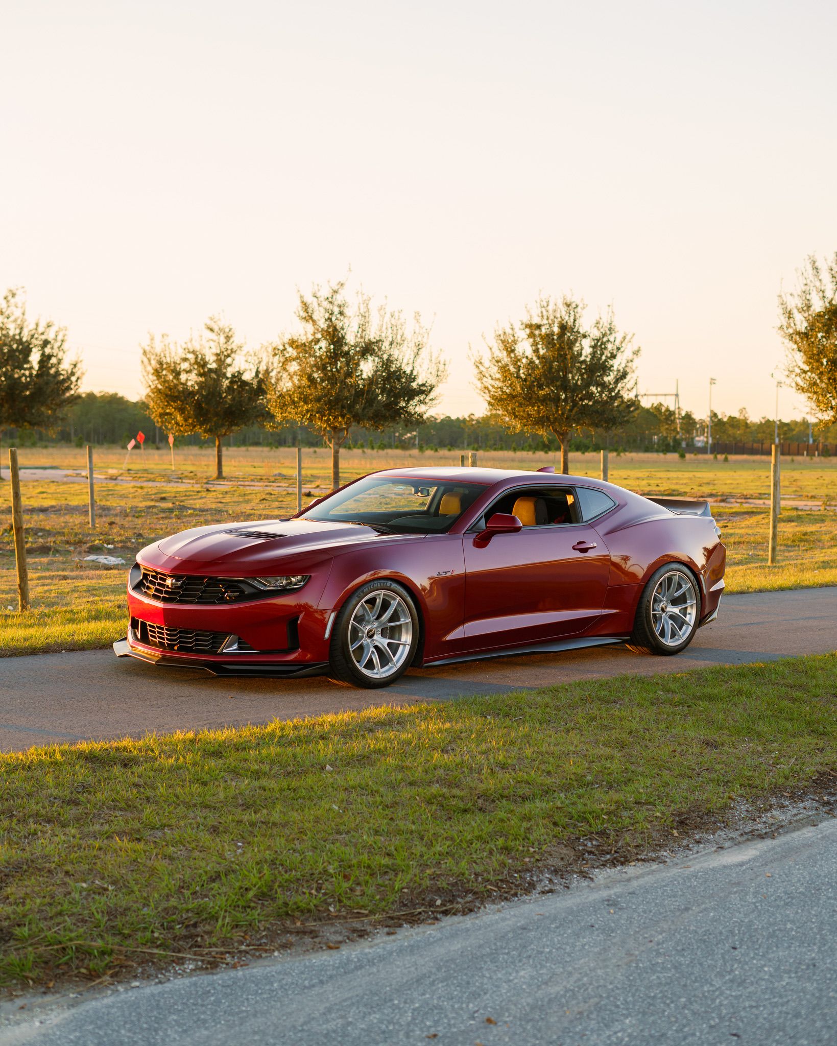 Red Chevrolet 6th Gen Camaro LT1 with 19" VS-5RS Apex wheels in Brushed Clear