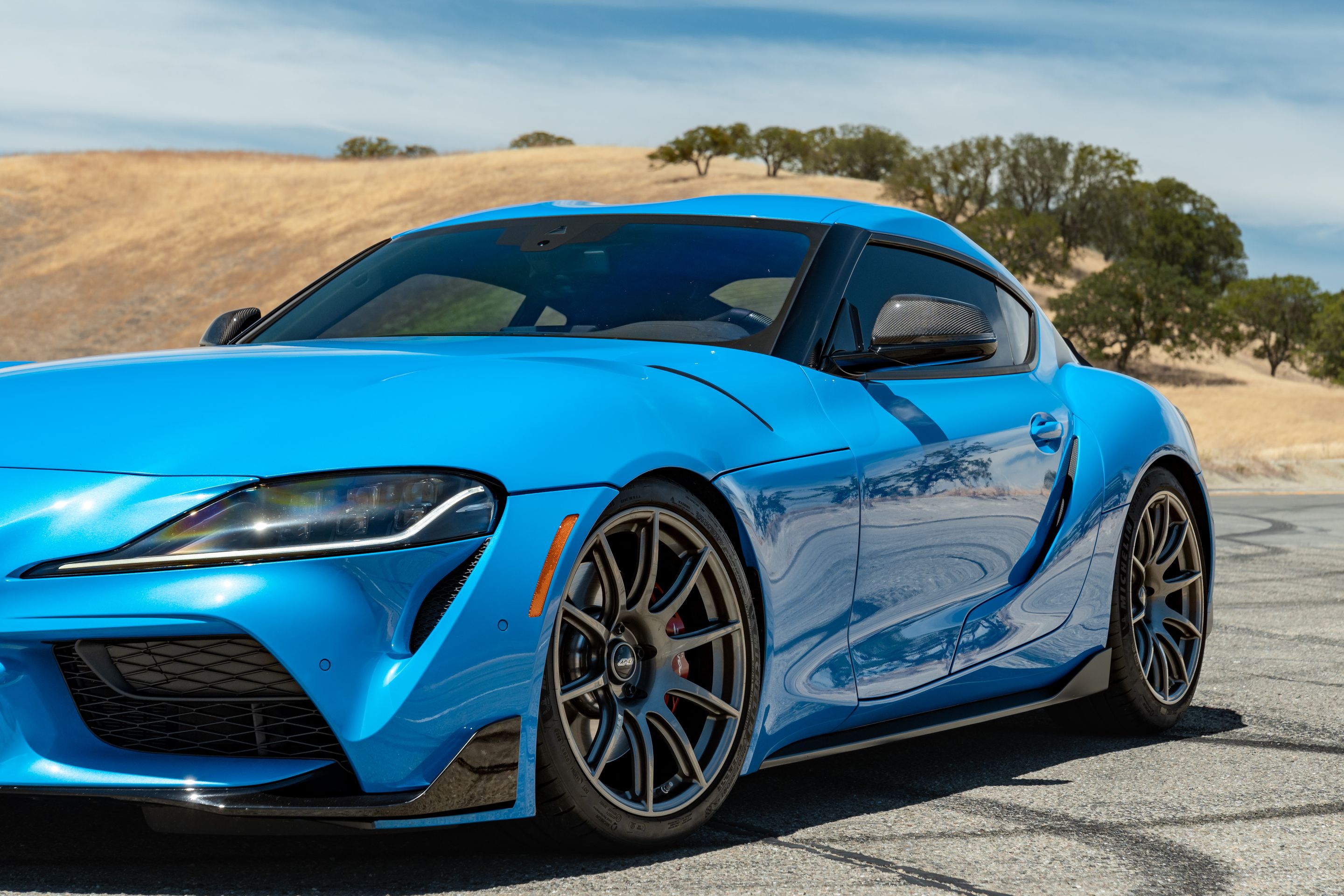 Blue Toyota GR Supra with 19" SM-10 Apex wheels in Anthracite