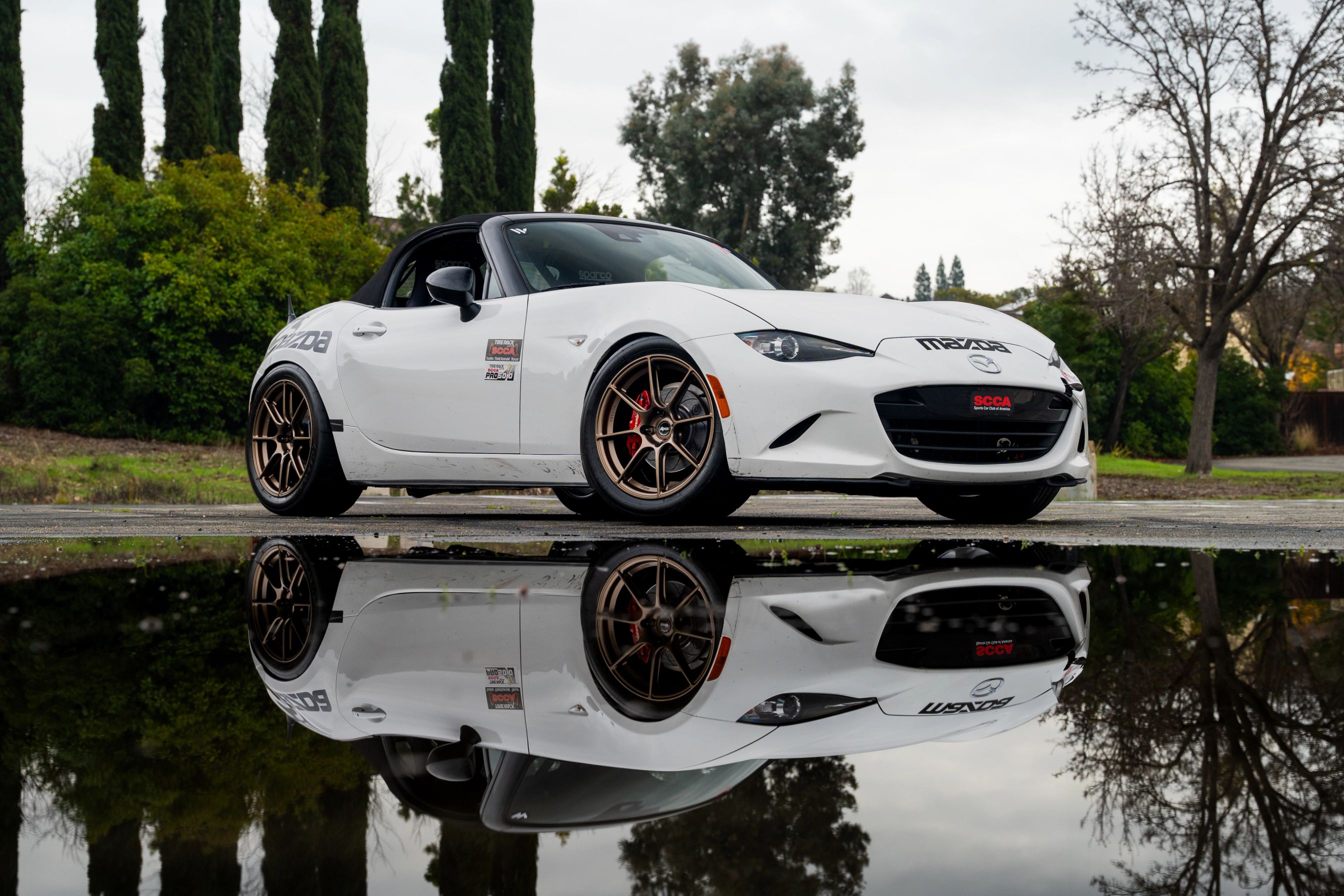 White Mazda ND MX-5 Miata with 17" SM-8RS Apex wheels in Satin Bronze