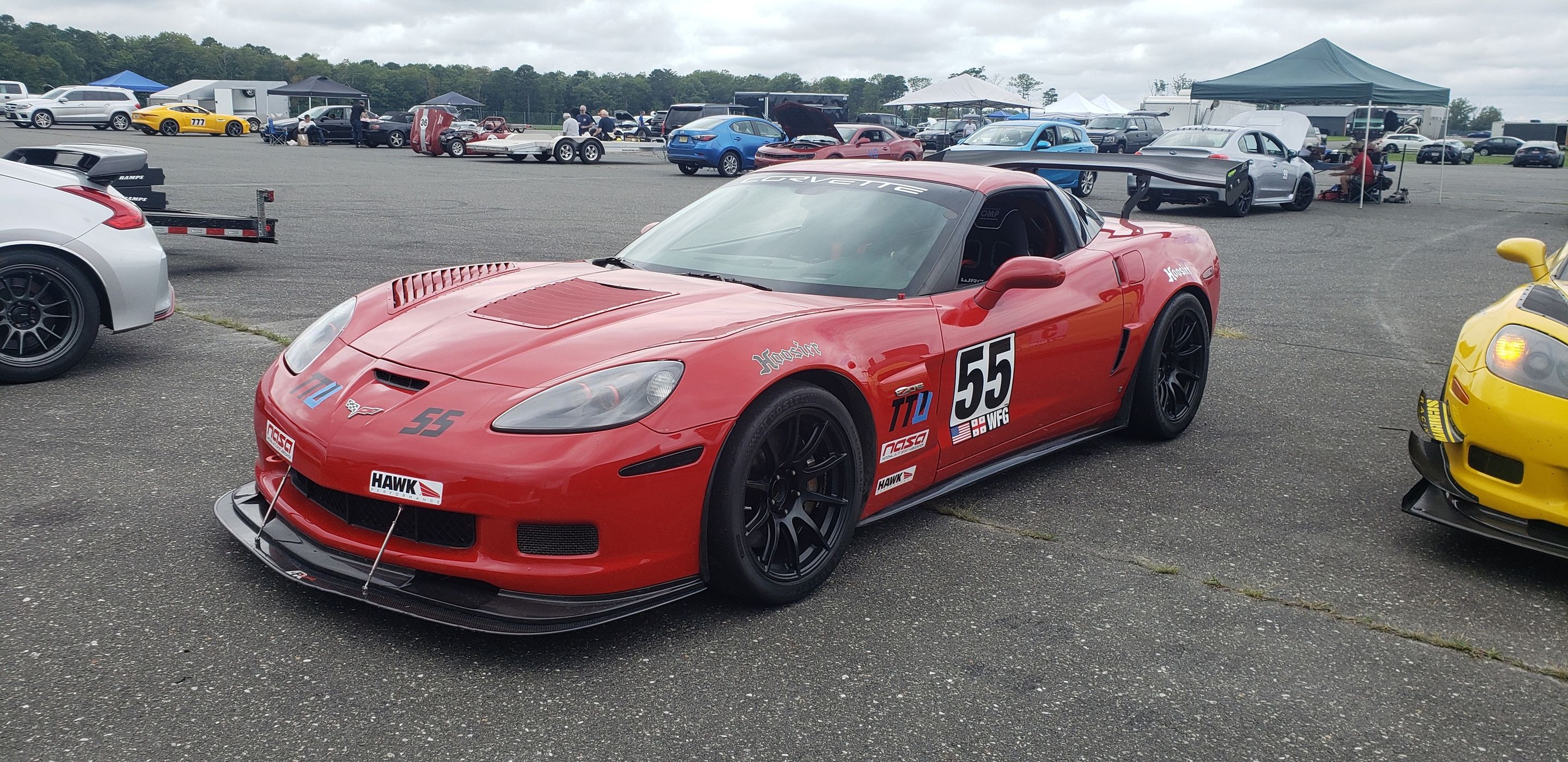 Red Chevrolet C6 Corvette Z06 with 18" SM-10 Apex wheels in Satin Black