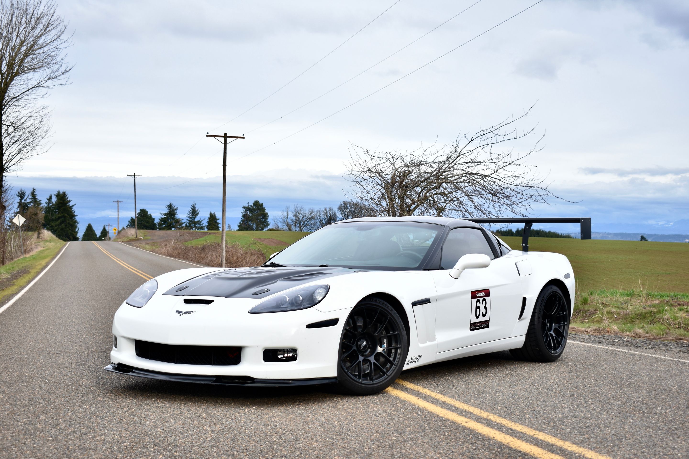 White Chevrolet C6 Corvette Grand Sport with 18"/19" EC-7RS Apex wheels in Satin Black