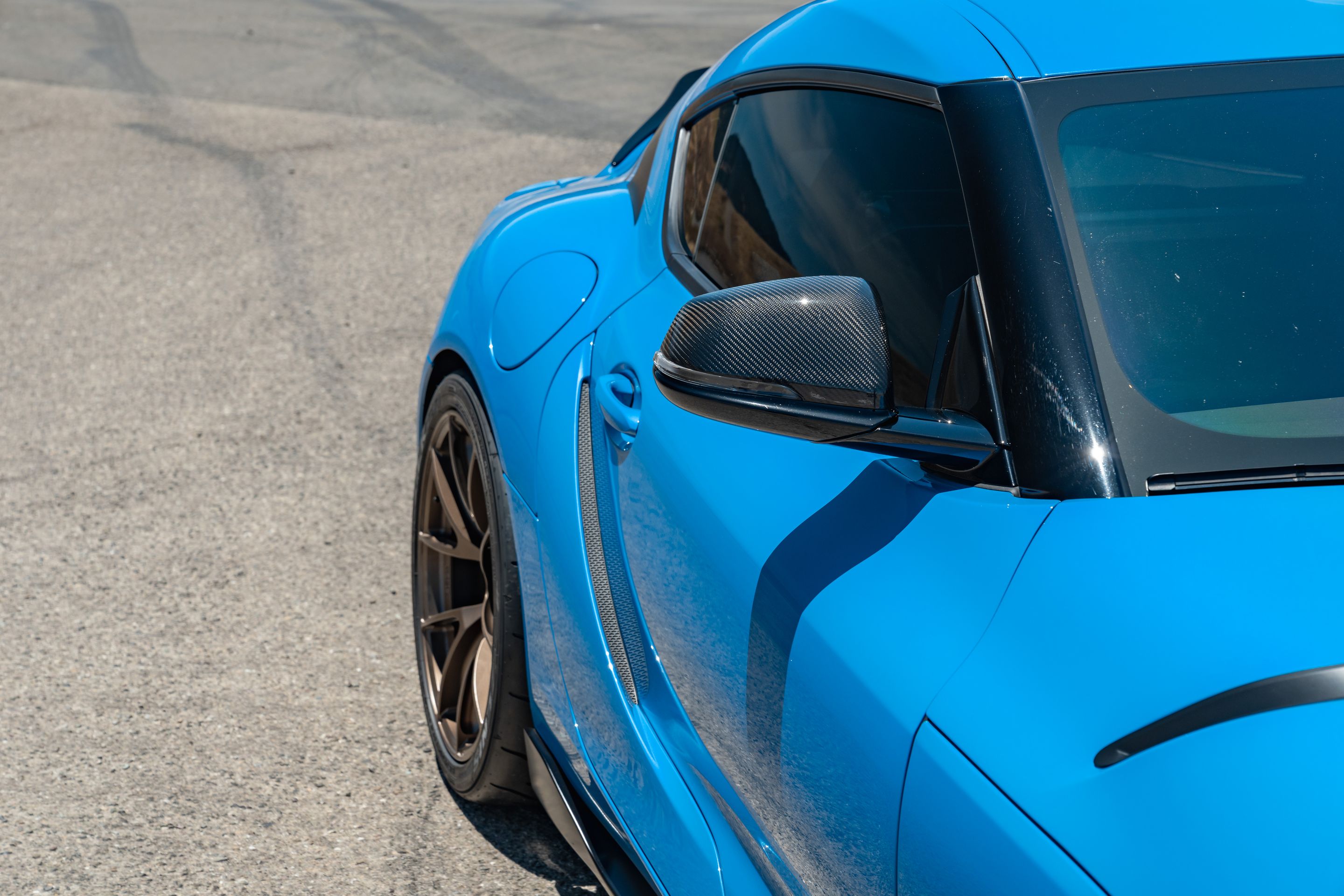 Blue Toyota GR Supra with 19" VS-5RS Apex wheels in Satin Bronze