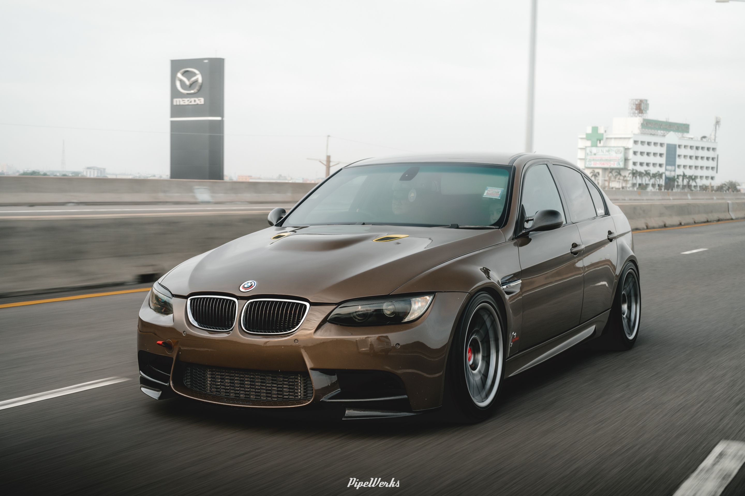 Brown BMW E90 Sedan 3 Series with 18" ARC-8 Apex wheels in Hyper Black