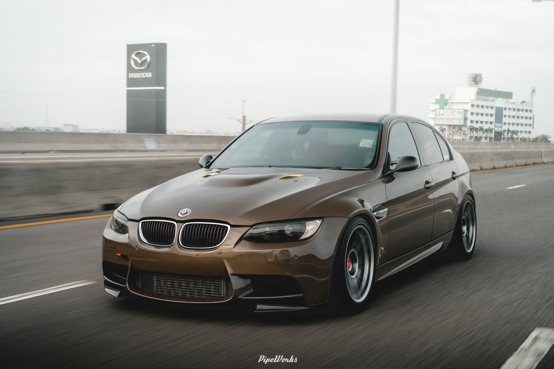 Brown BMW E90 Sedan 3 Series with 18" ARC-8 Apex wheels in Hyper Black