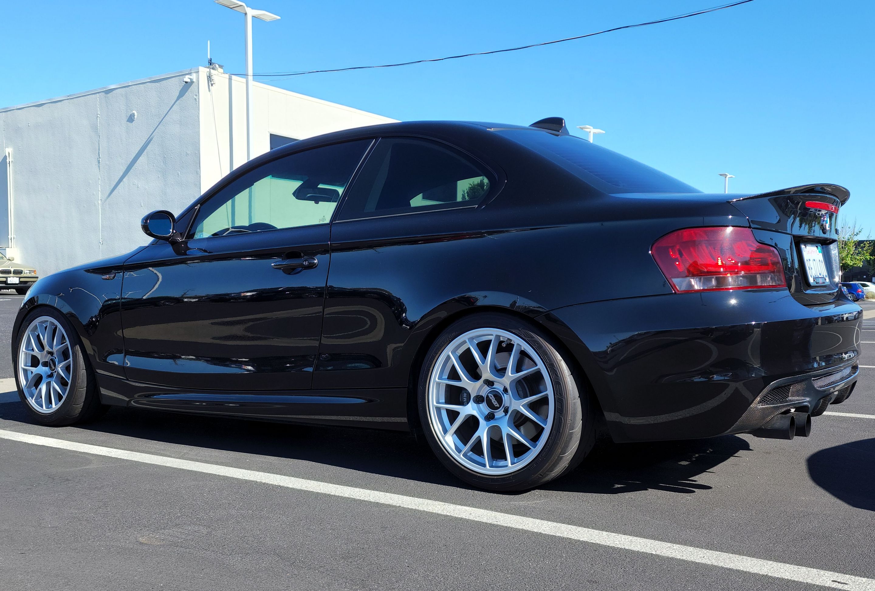 Black BMW E82 Coupe 1 Series with 18" EC-7 Apex wheels in Race Silver
