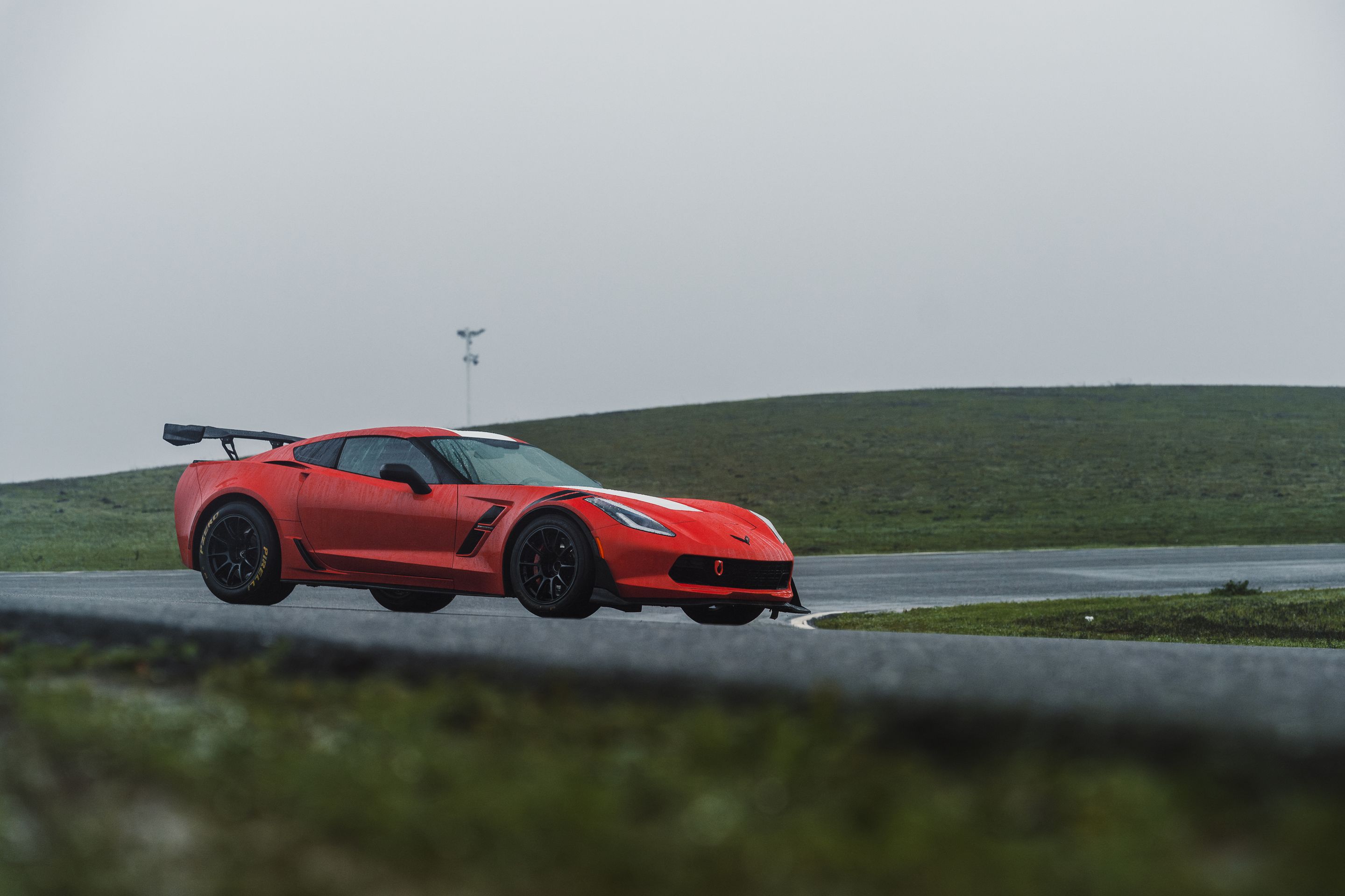 Red Chevrolet C7 Corvette Grand Sport with 18" SM-10RE Apex wheels in Satin Black