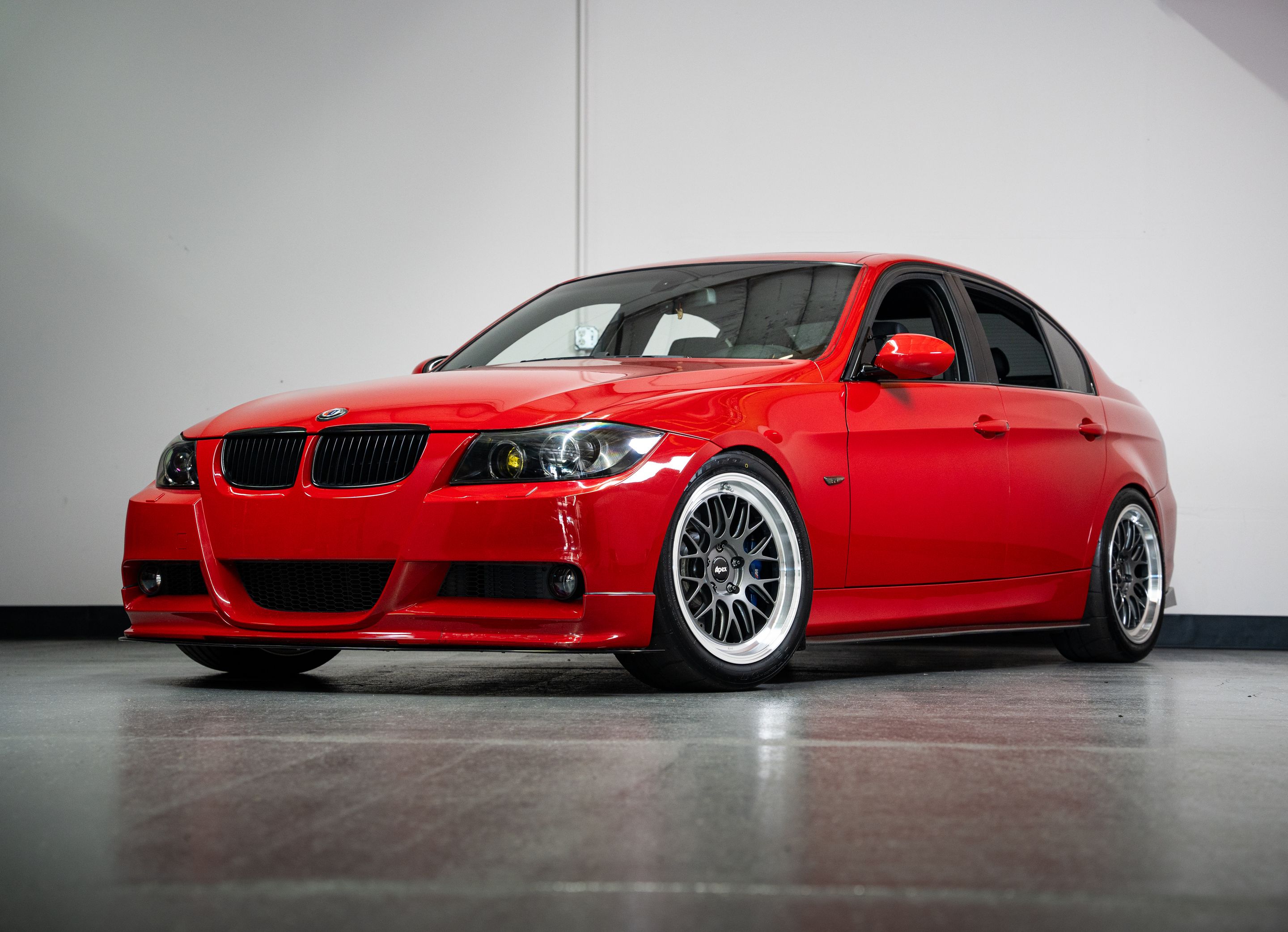 Red BMW E90 Sedan 3 Series with 18" ML-10RT Apex wheels in Machined Lip Anthracite