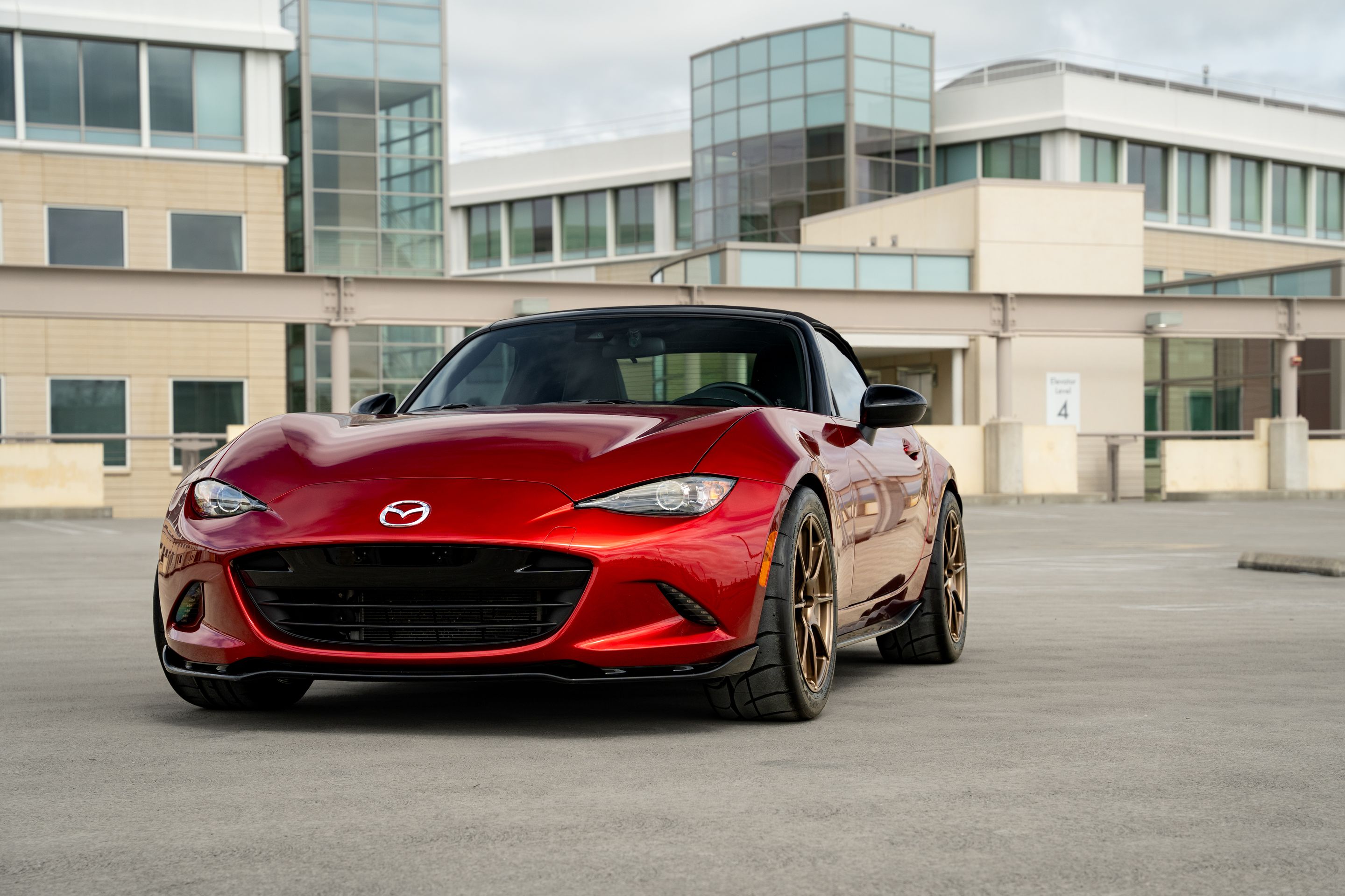 Red Mazda ND MX-5 Miata with 17" SM-8RS Apex wheels in Satin Bronze
