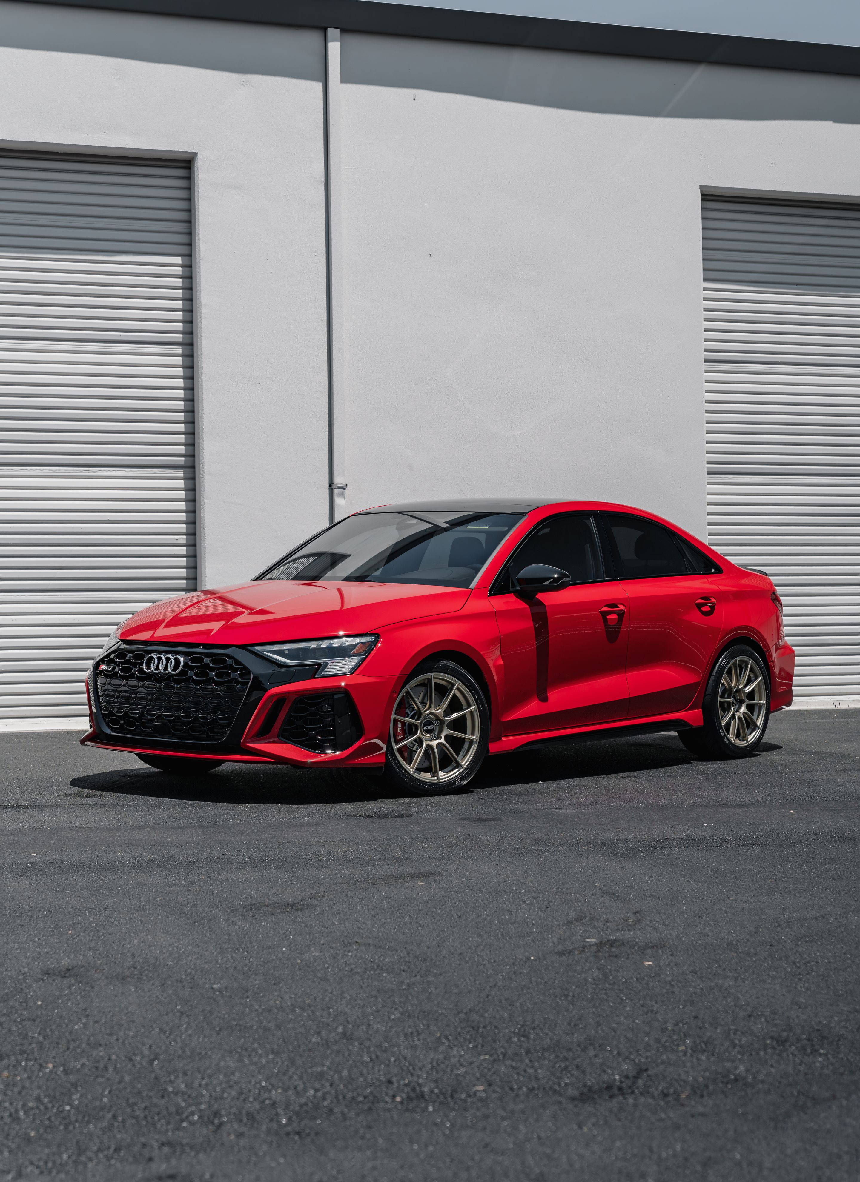 Red Audi 8Y RS 3 with 18" SM-10RS Apex wheels in Motorsport Gold