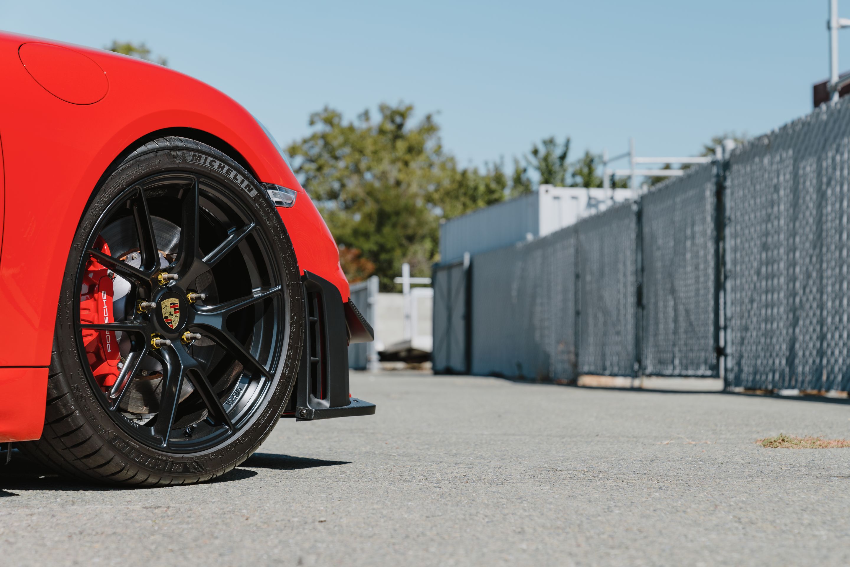 Red Porsche 718 Cayman GT4 with 19" VS-5RS Apex wheels in Satin Black