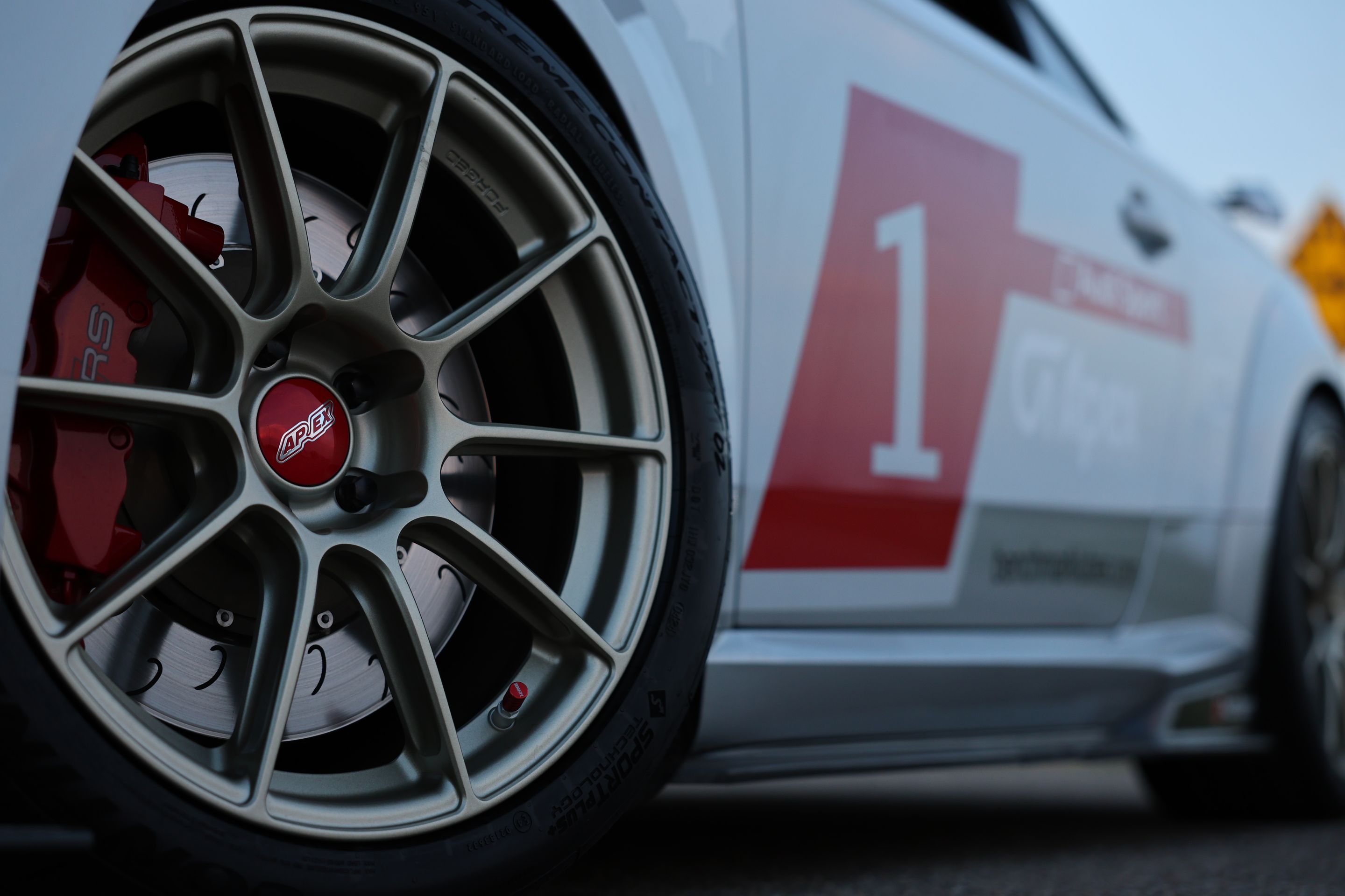 White Audi FV/8S TT RS with 18" SM-10RS Apex wheels in Motorsport Gold
