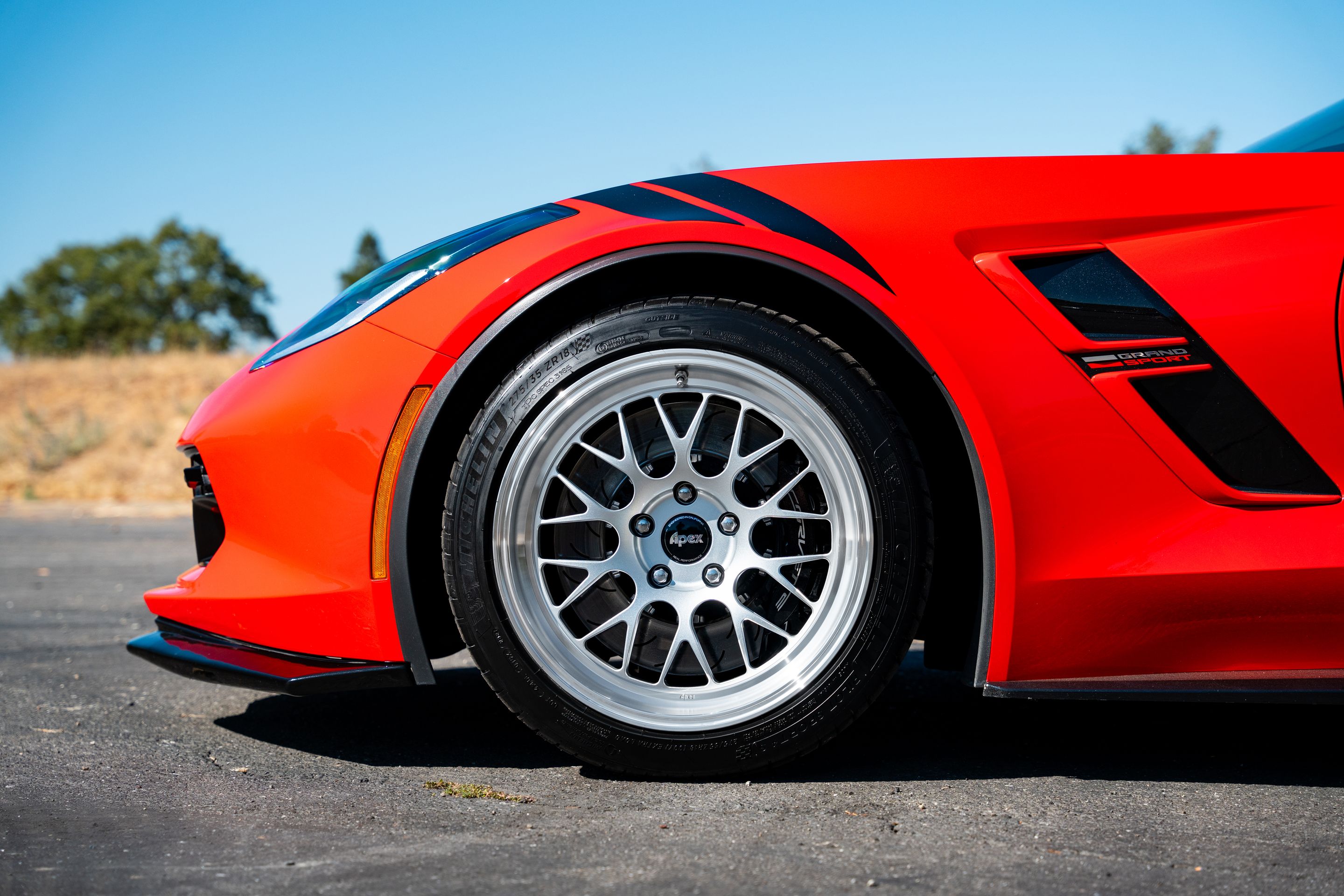 Red Chevrolet C7 Corvette Grand Sport with 18"/19" ML-10RT Apex wheels in Machined Lip Race Silver