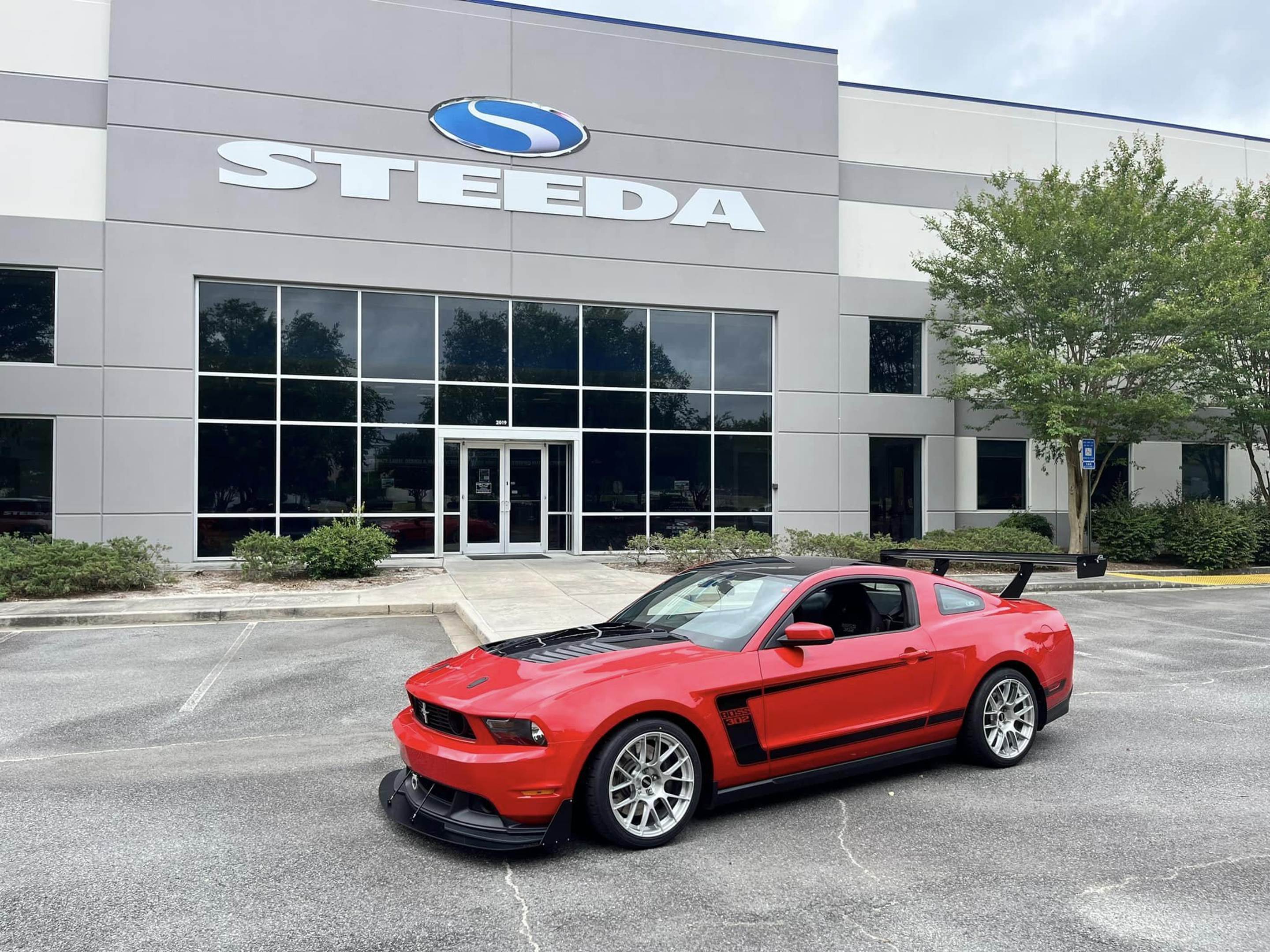 Red Ford S197 Mustang Boss 302 with 18" EC-7RS Apex wheels in Brushed Clear
