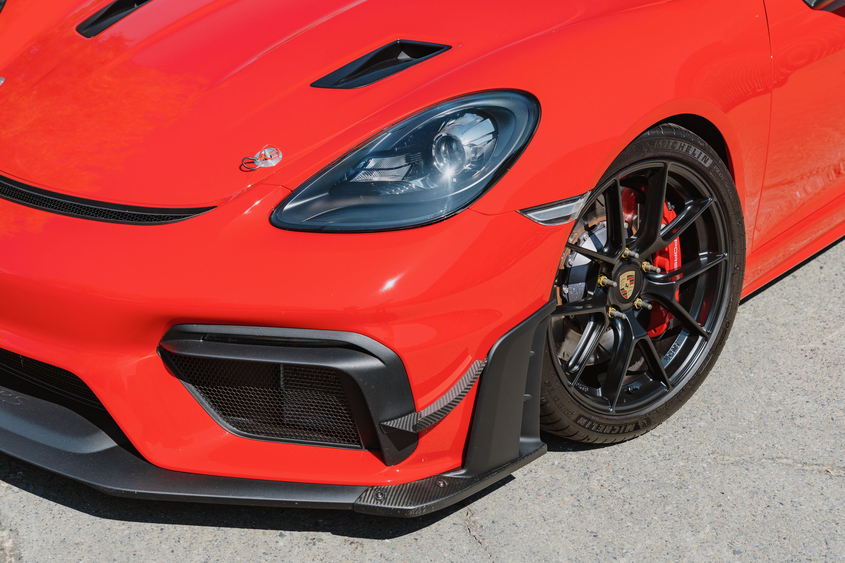 Red Porsche 718 Cayman GT4 with 19" VS-5RS Apex wheels in Satin Black