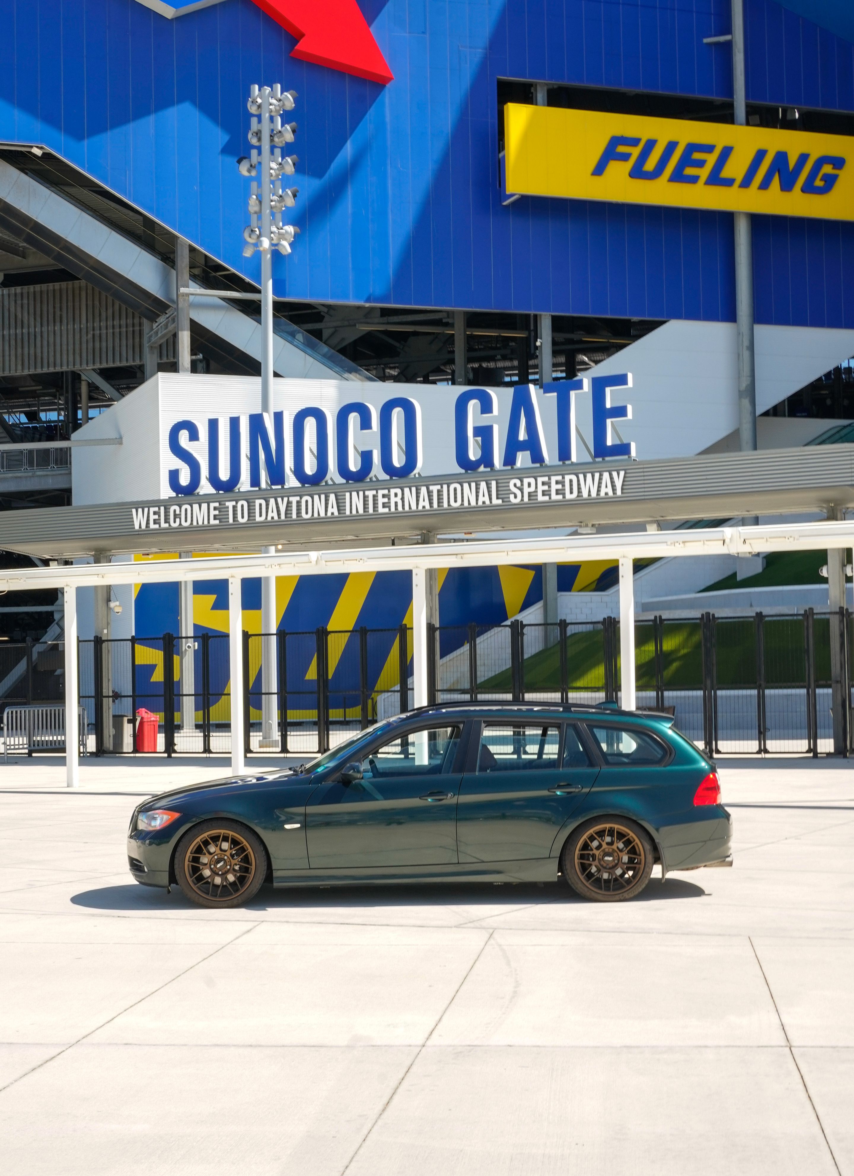 Green BMW E91 Wagon 3 Series with 18" ARC-8 Apex wheels in Satin Bronze