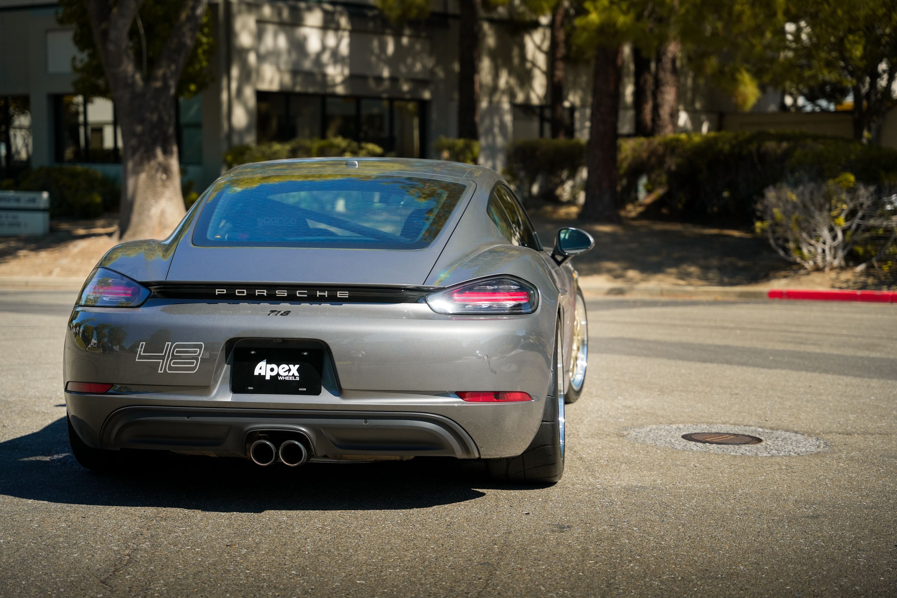 Grey Porsche 718 Cayman S with 18" ML-10RT Apex wheels in Machined Lip Gloss Motorsport Gold