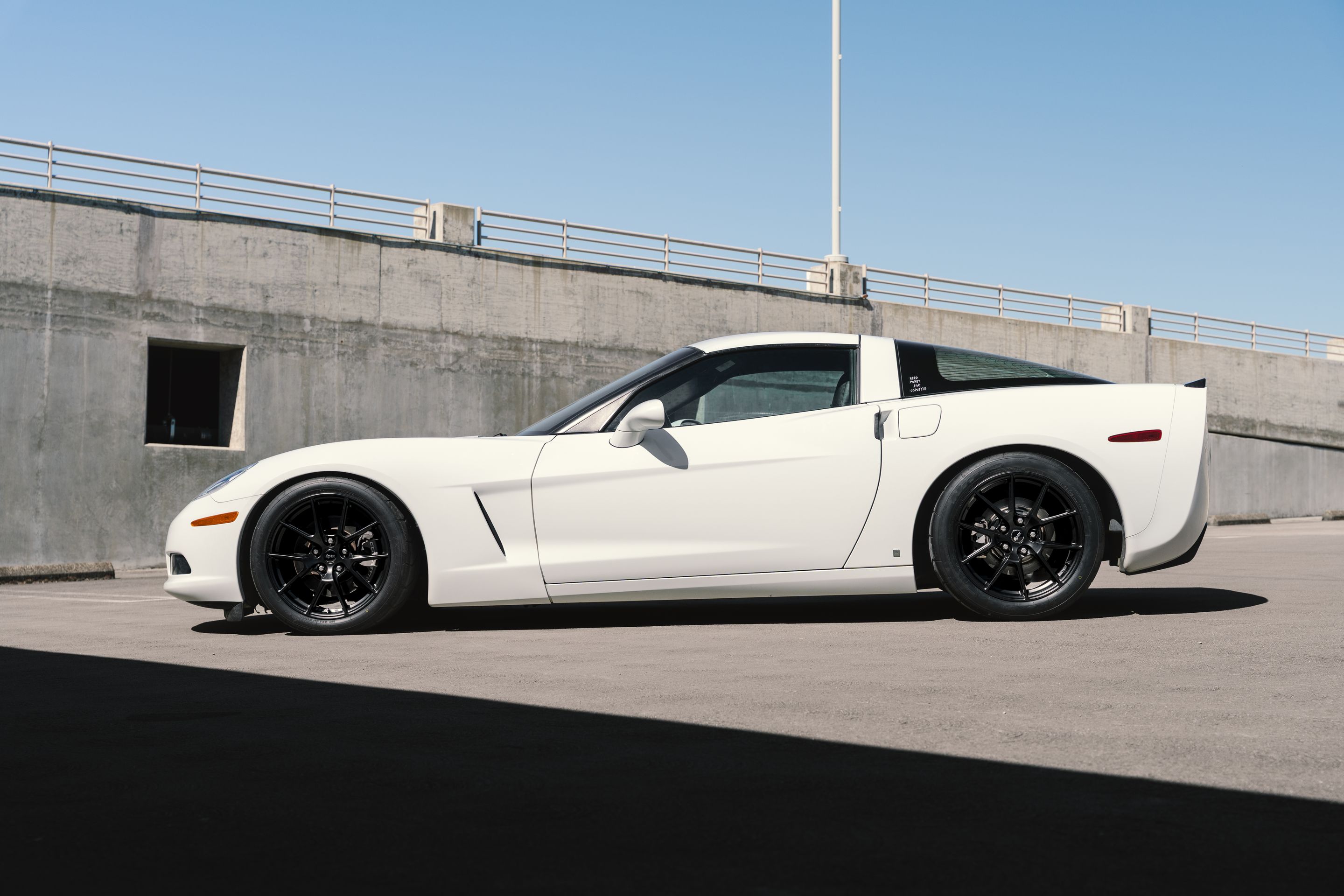 White Chevrolet C6 Corvette Base/Z51 with 18" VS-5 Apex wheels in Satin Black