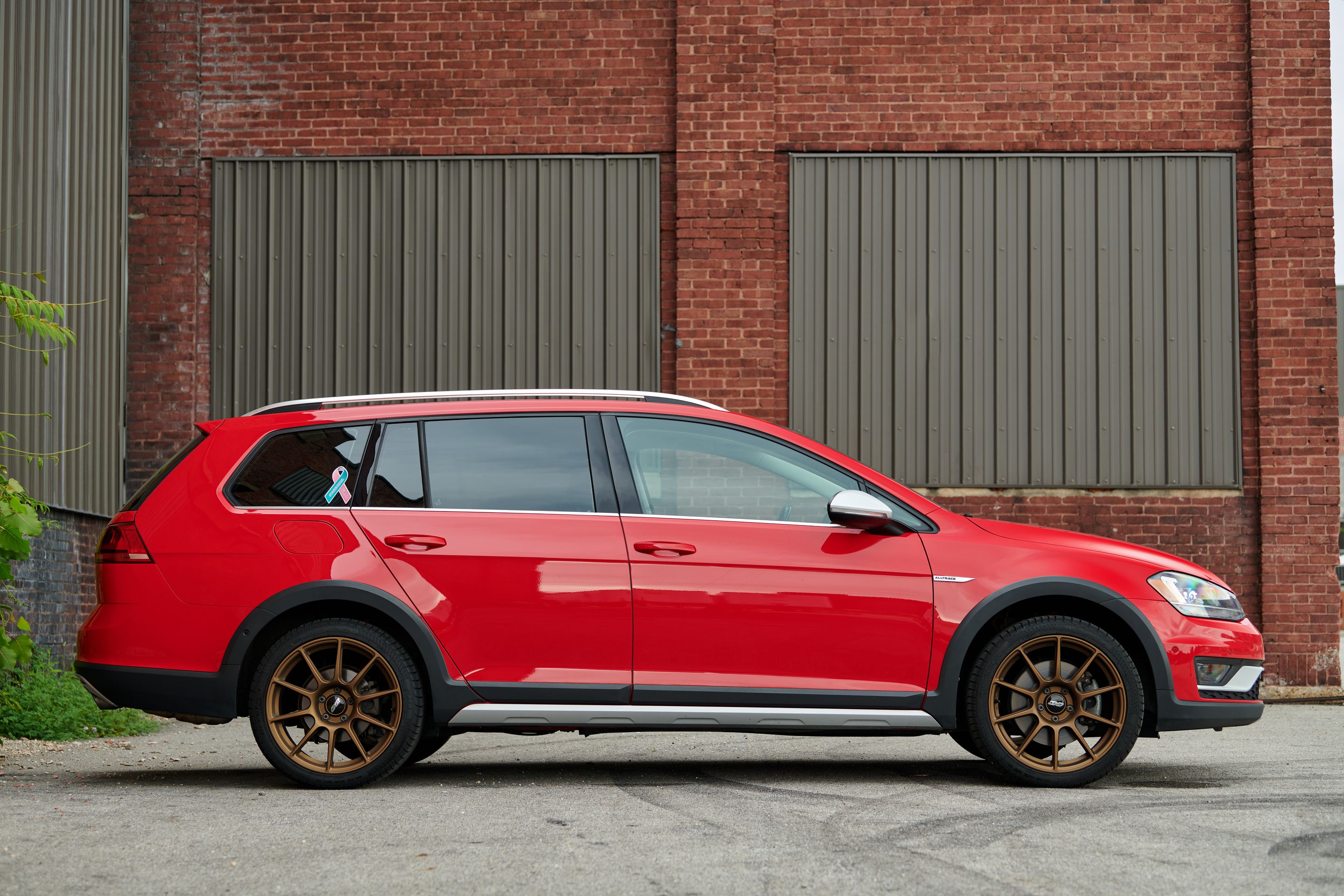 Red VW MK7 Alltrack/SportWagen Alltrack with 18" SM-10 Apex wheels in Satin Bronze