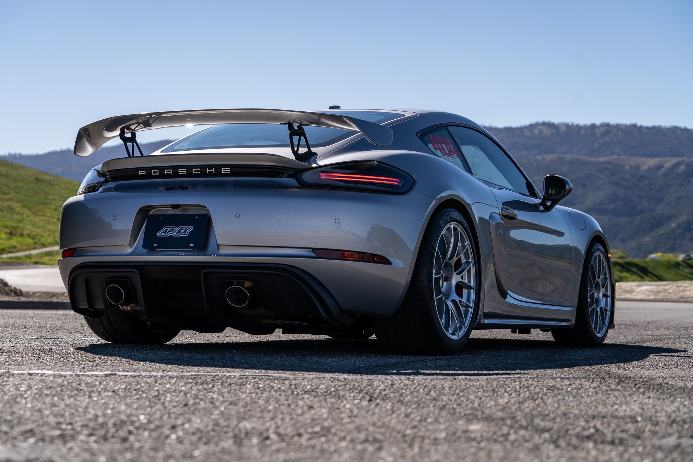 Grey Porsche 718 Cayman GT4 with 19" EC-7RS Apex wheels in Race Silver