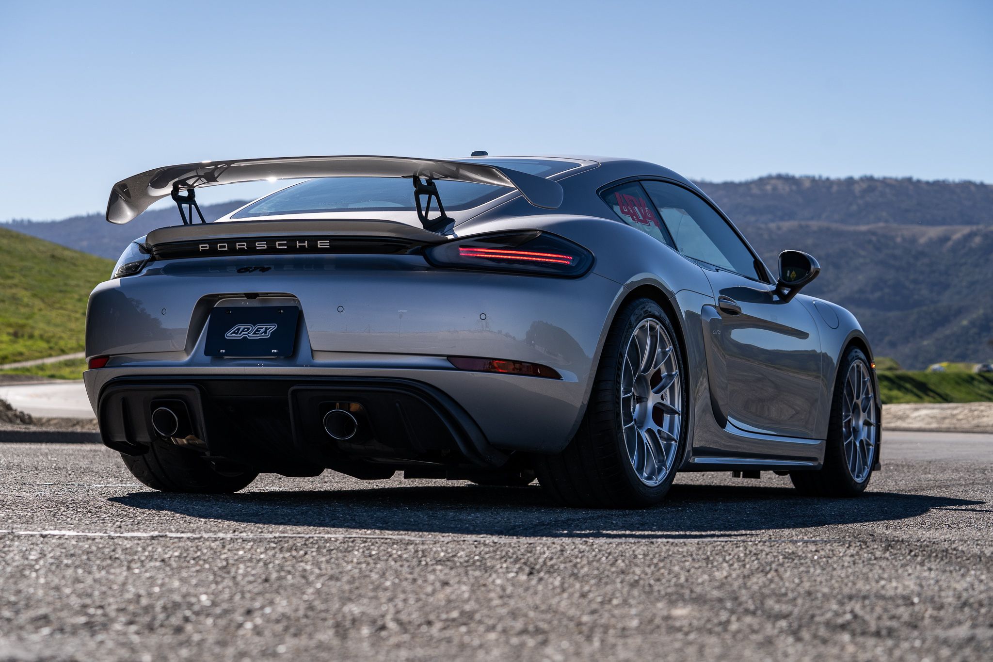Grey Porsche 718 Cayman GT4 with 19" EC-7RS Apex wheels in Race Silver