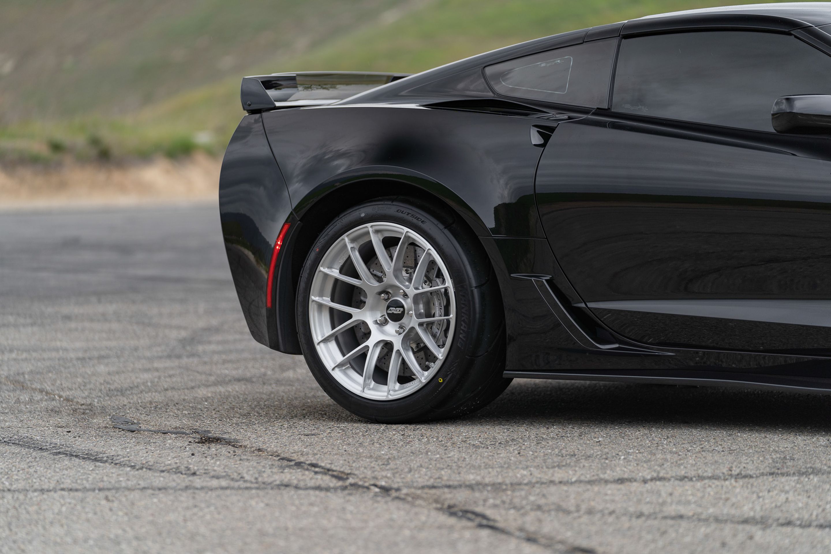 Black Chevrolet C7 Corvette Z06 with 18"/19" EC-7RS Apex wheels in Brushed Clear