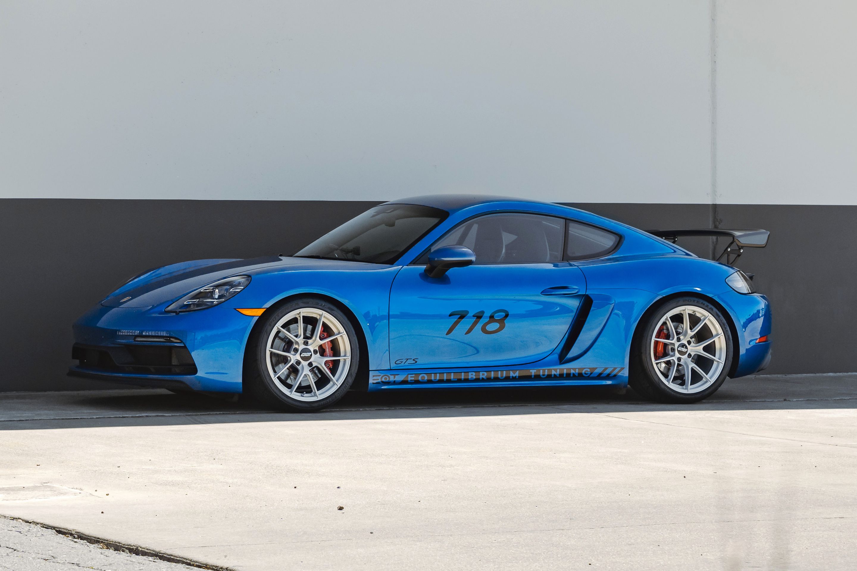Blue Porsche 718 Cayman GTS 2.5L with 19" VS-5RS Apex wheels in Brushed Clear